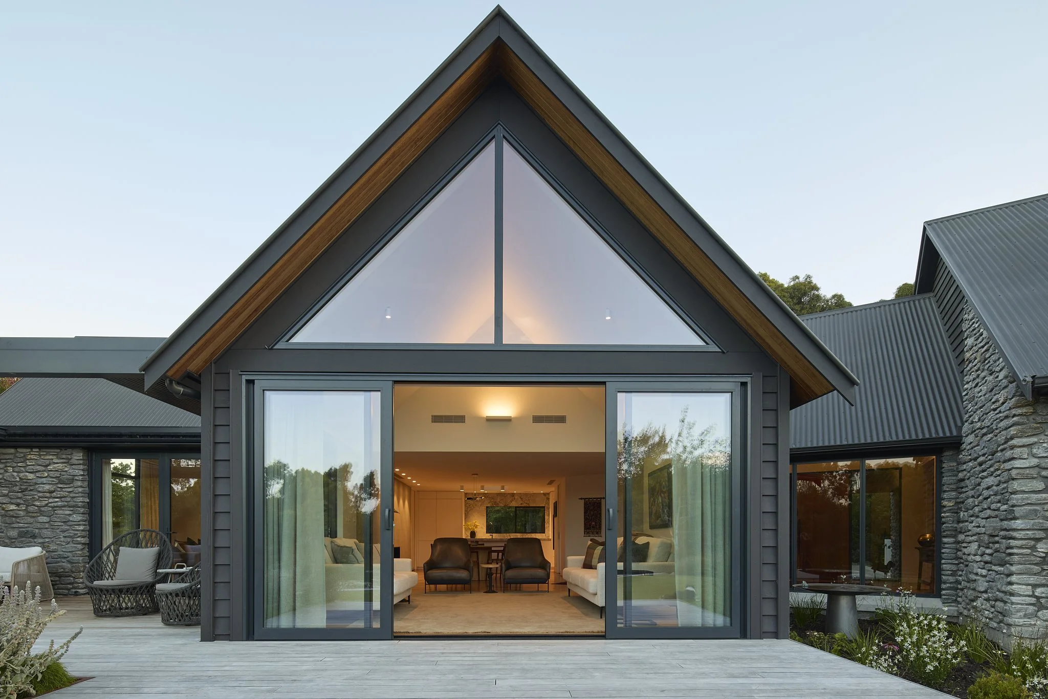 Gabled architectural façade with large sliding glass doors
