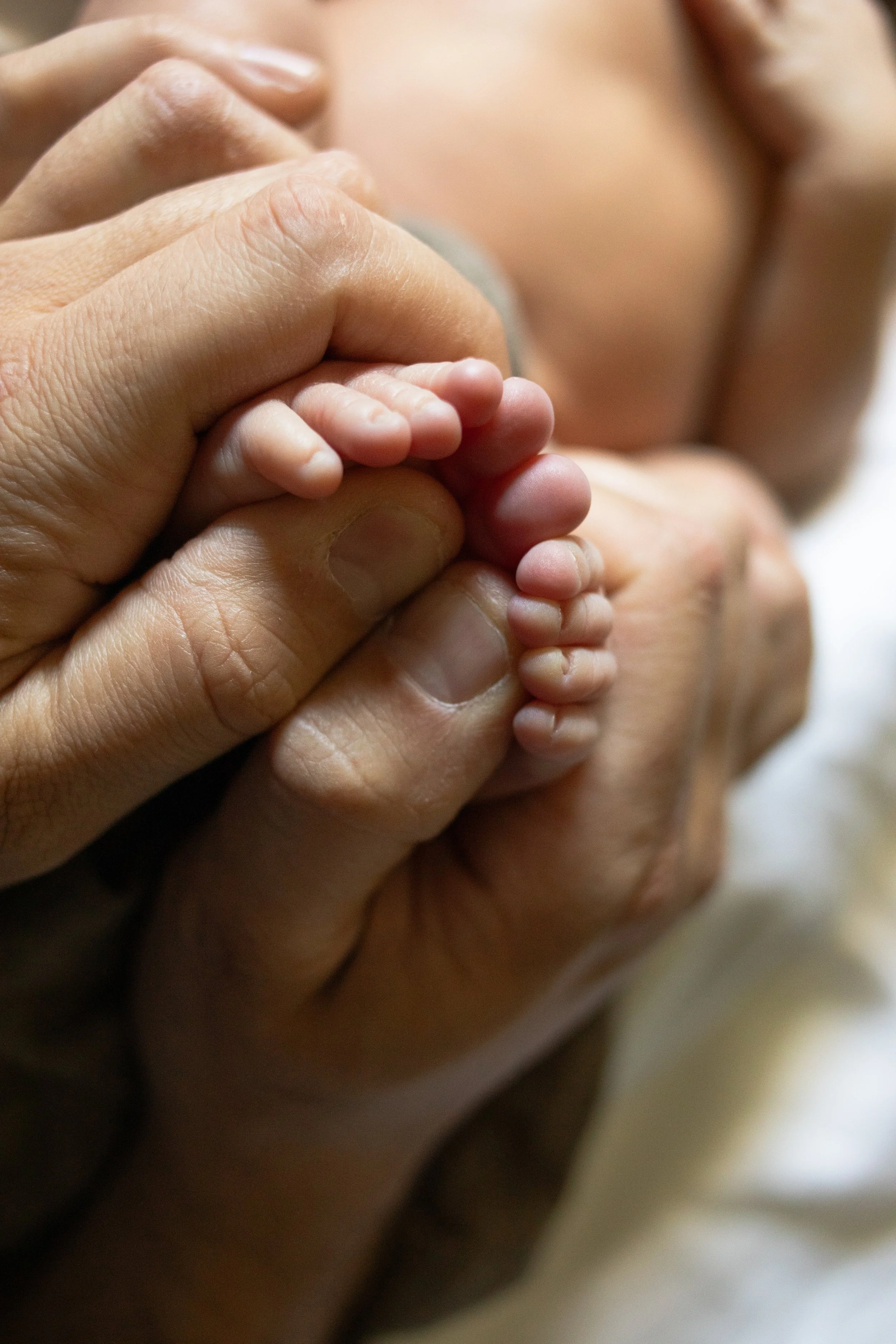 Newborn Toes Wrapped Around Thumbs