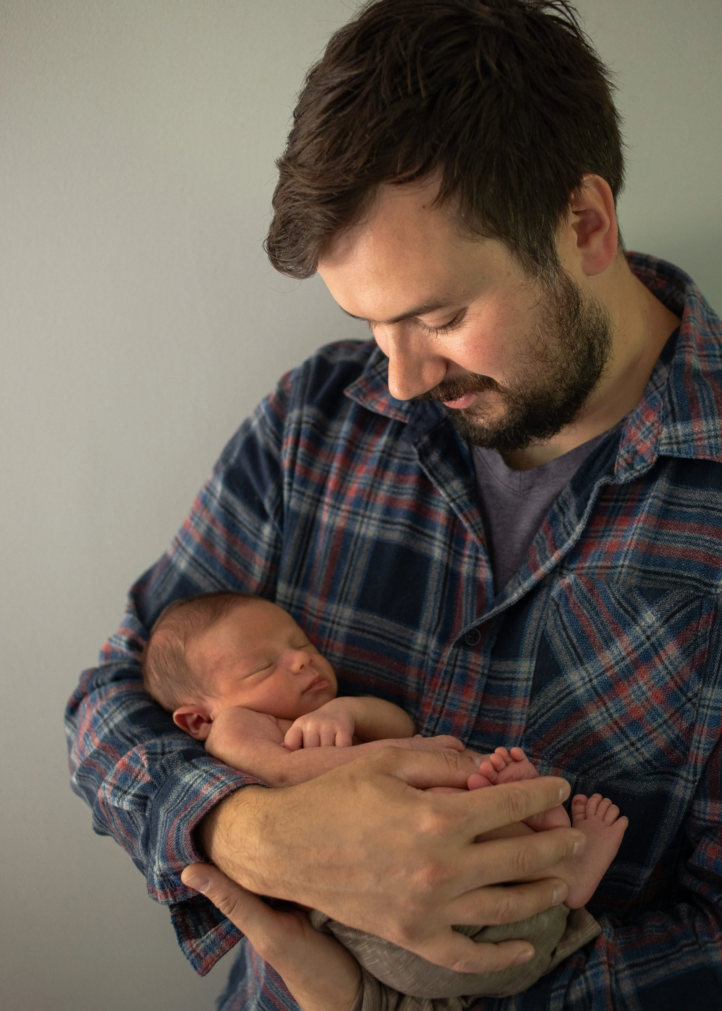 Dad Holding Newborn Baby