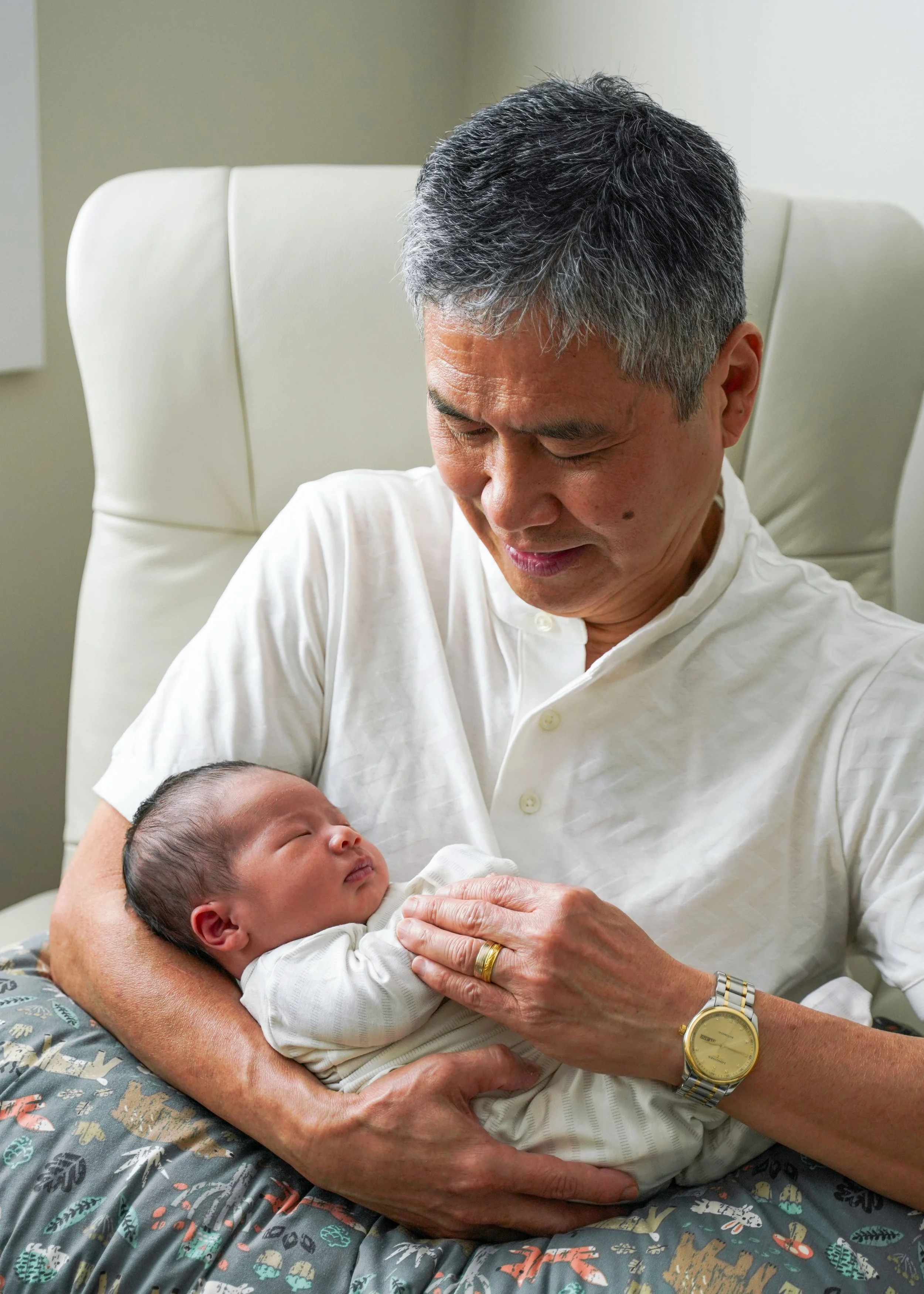 Newborn with Grandfather in Rocking Chair