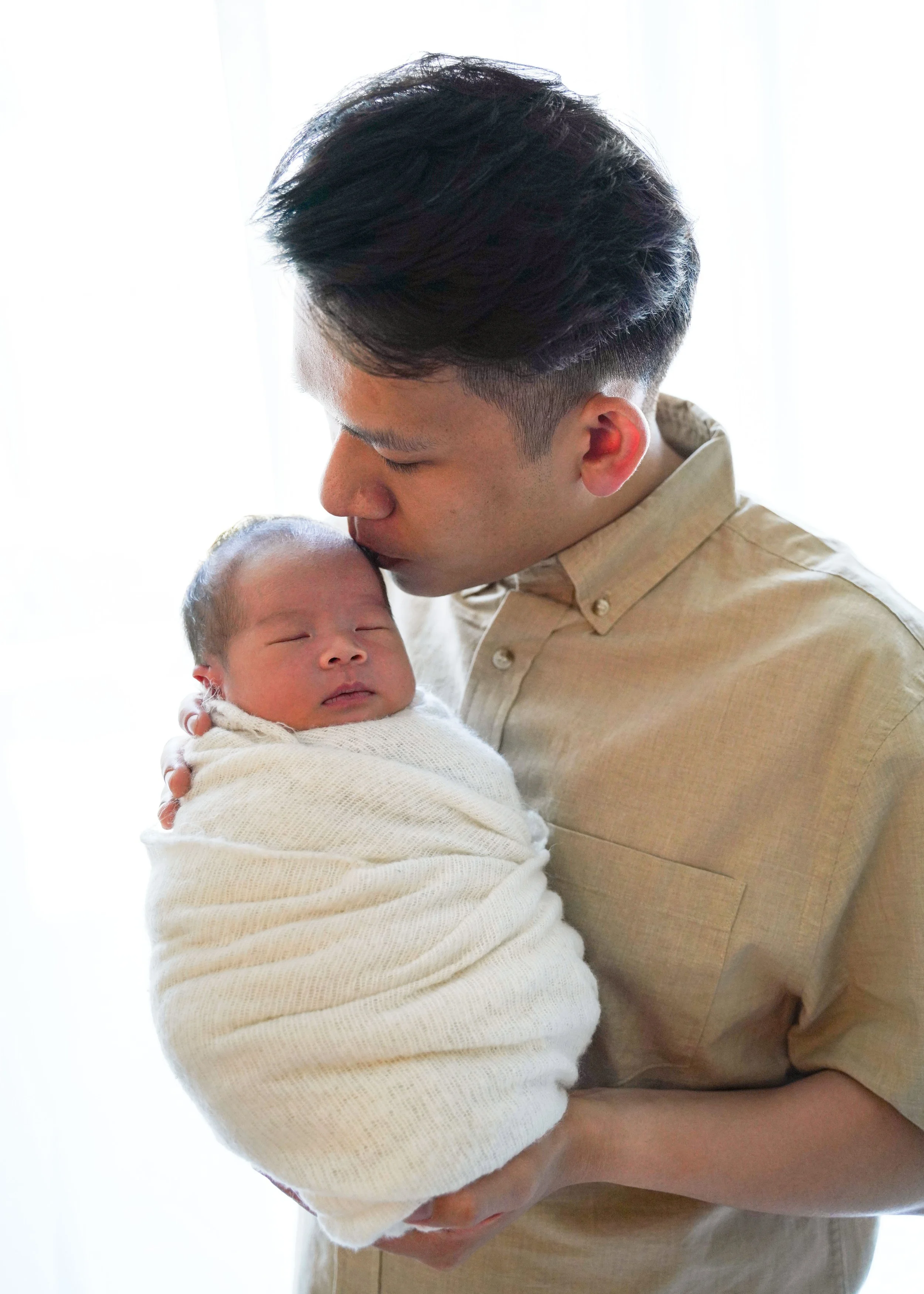 Dad Kissing Newborn
