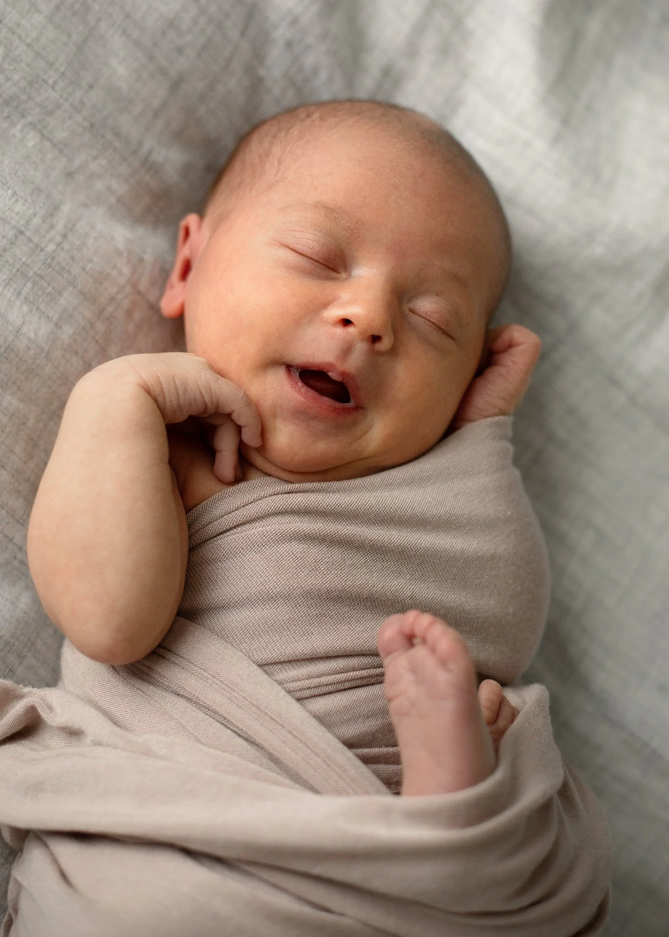 Lifestyle newborn photography is all about capturing your family naturally &mdash; the gentle, perfectly imperfect moments that unfold in between. Like this sweet little one, peacefully asleep, wrapped in natural movement, soft connection, and the ki