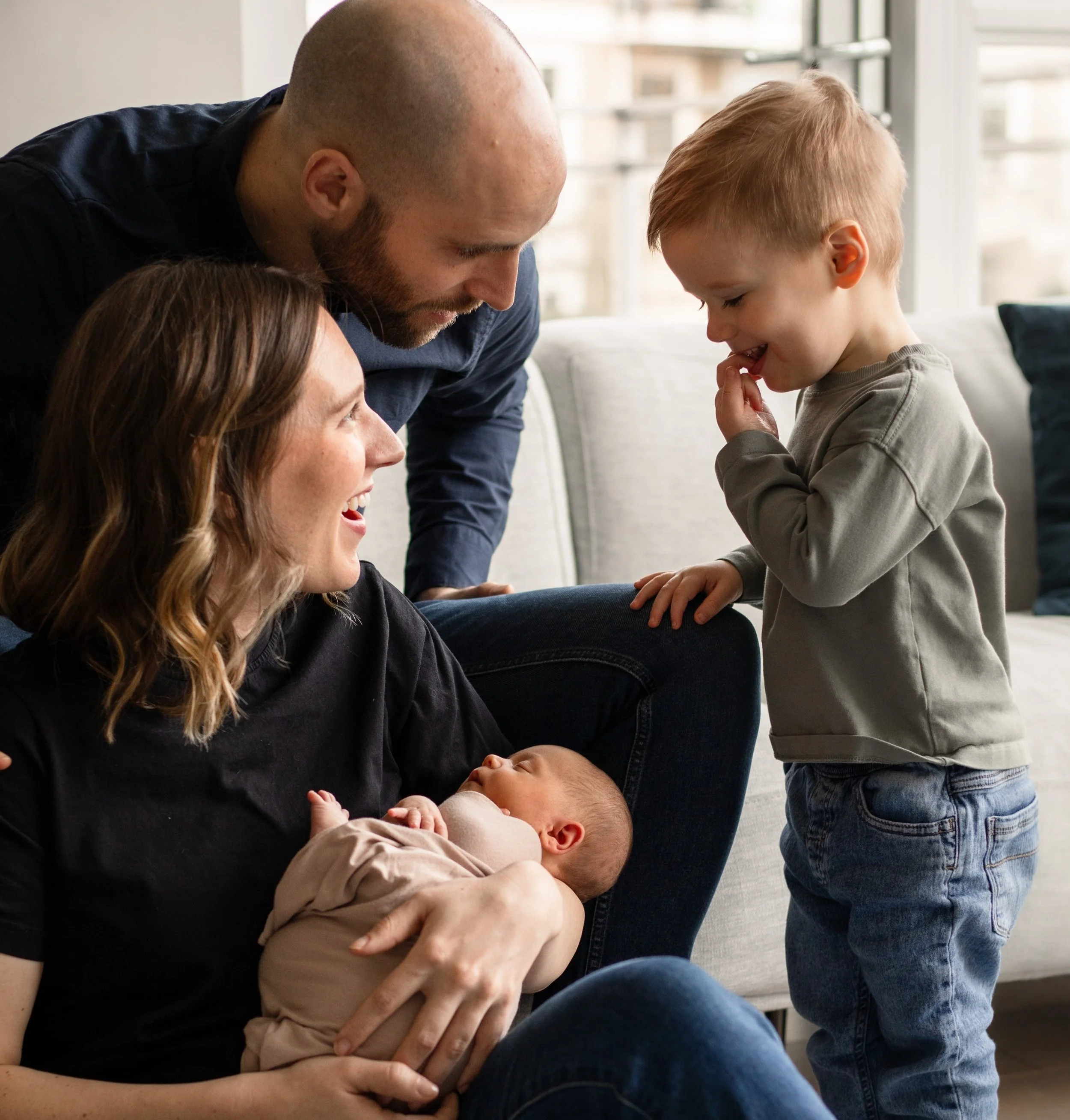 Older brother meeting newborn sibling in family home