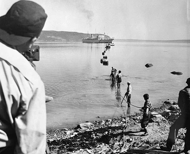 Workmen Pulling Cable Ashore 1955 Old Photo - Laying of the world's first transatlantic telephone cable was started recently at Clarenville, Newfoundland with dignitaries of the U.S., Britain.webp