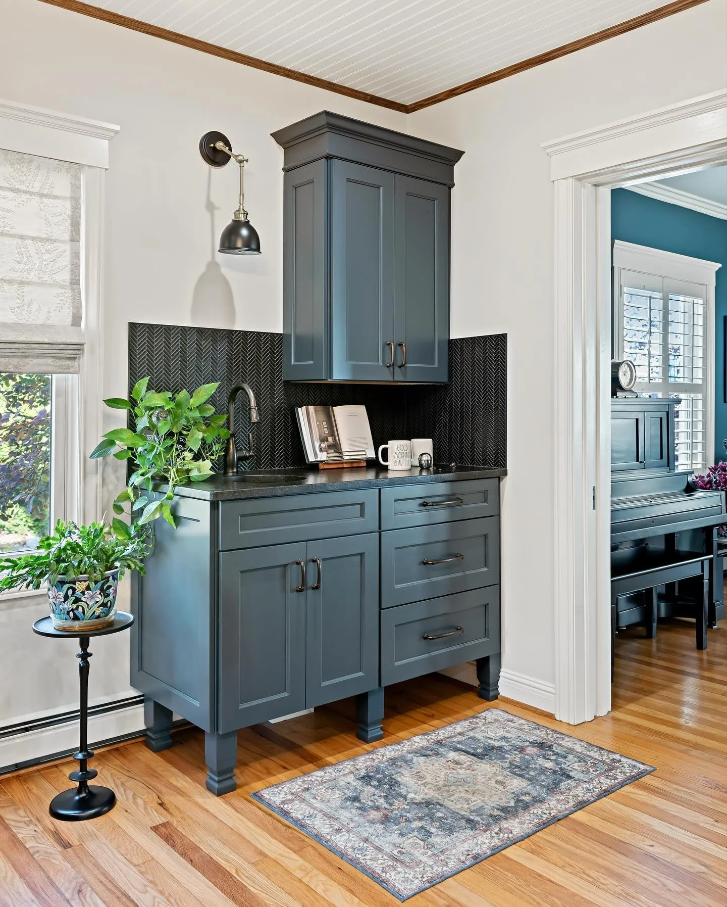 Your Monday morning just got an upgrade. This custom coffee bar brings together rich cabinetry, fresh greens, and a timeless black herringbone backsplash, creating a little moment of calm right where the day begins. 

Designed to serve your lifestyle