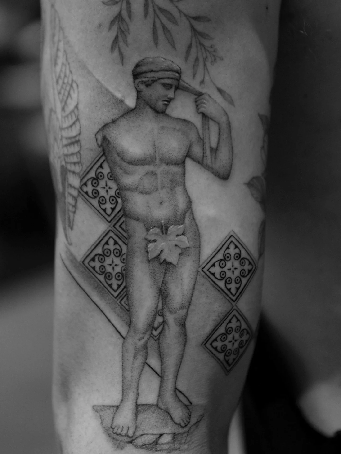 Daidoumenos of Vaison for Randy&rsquo;s collection. 
The Greek then Roman interpretation of Olympic and athletic glory of mortals.

Added Portuguese Tile patterns in the background.

Really enjoying the statue approach for tattoos in this style. 
If 