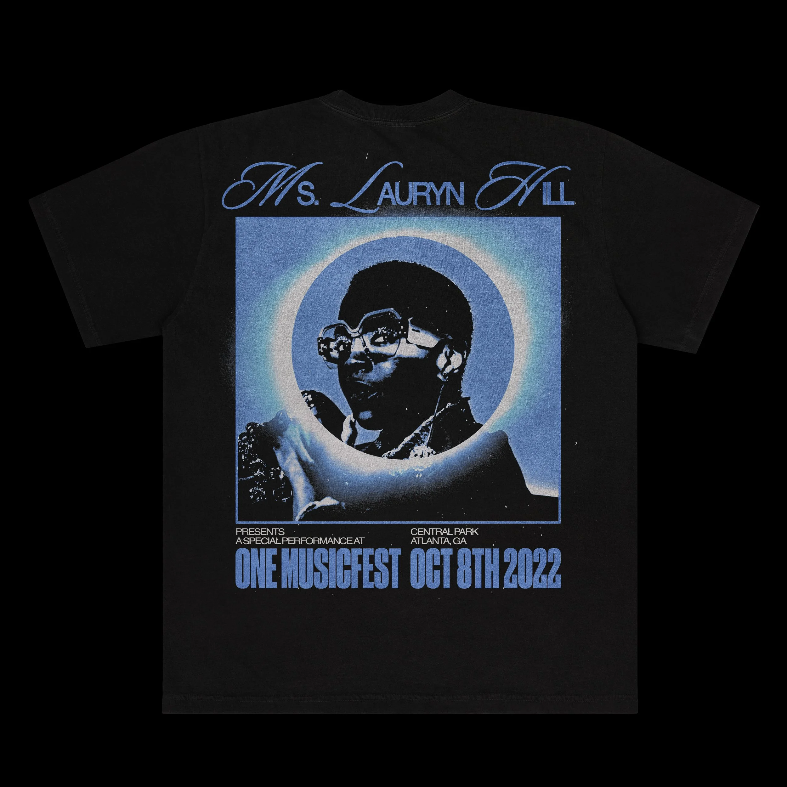 Black T-shirt with a stylized blue and white graphic of a person wearing glasses, sunglasses, and headphones. The shirt has the text 'Ms. Lauryn Hill' at the top and 'One Musicfest Oct 8th 2022' at the bottom, with smaller text about the event detail
