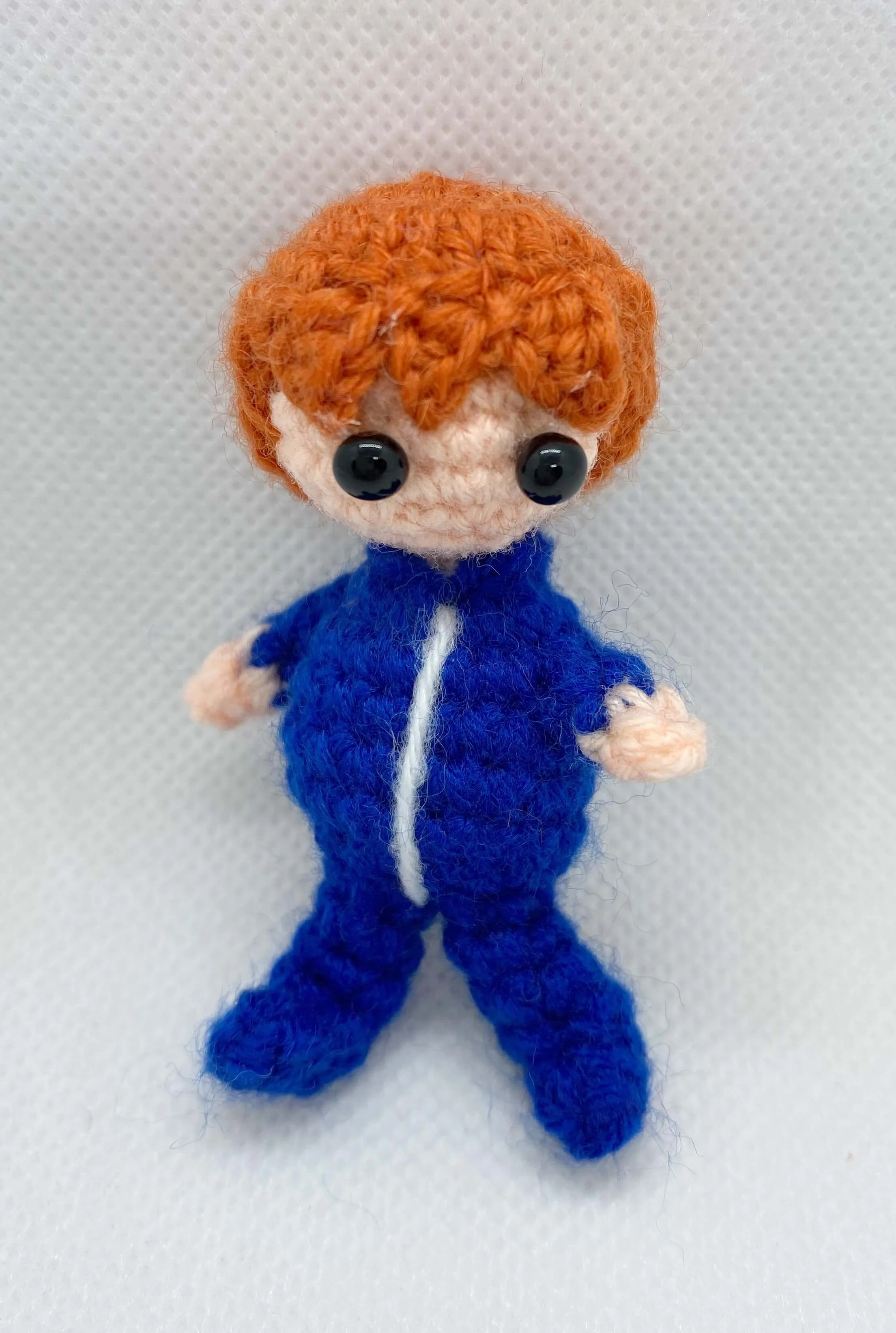 crochet boy in blue astronuat inner suit.jpg