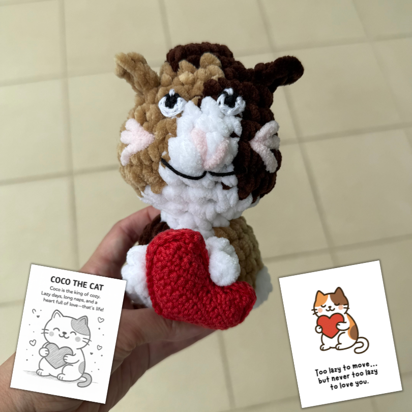 crochet cat hugging heart pillow.png