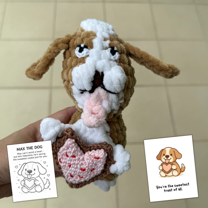 crochet dog holding a heart cookie.png