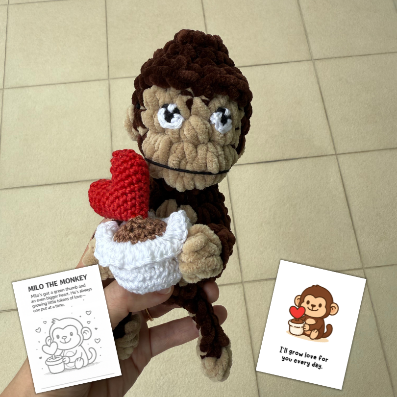 crochet monkey holding up potted heart plant.png