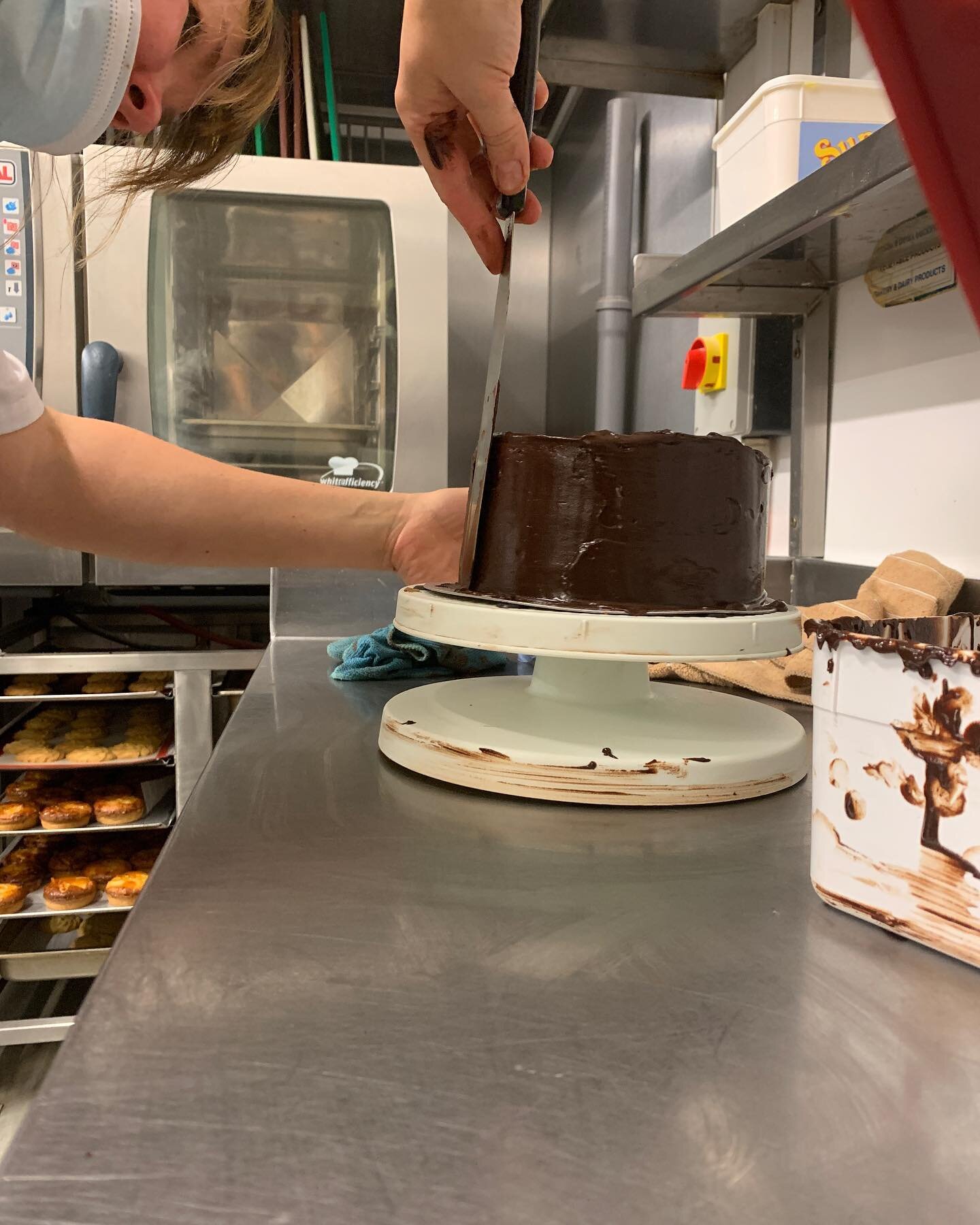 Olga busy icing our chocolate cakes 
#behindthescenes #chocolatecake #icing #bakery #thegranary #eastcorkfood