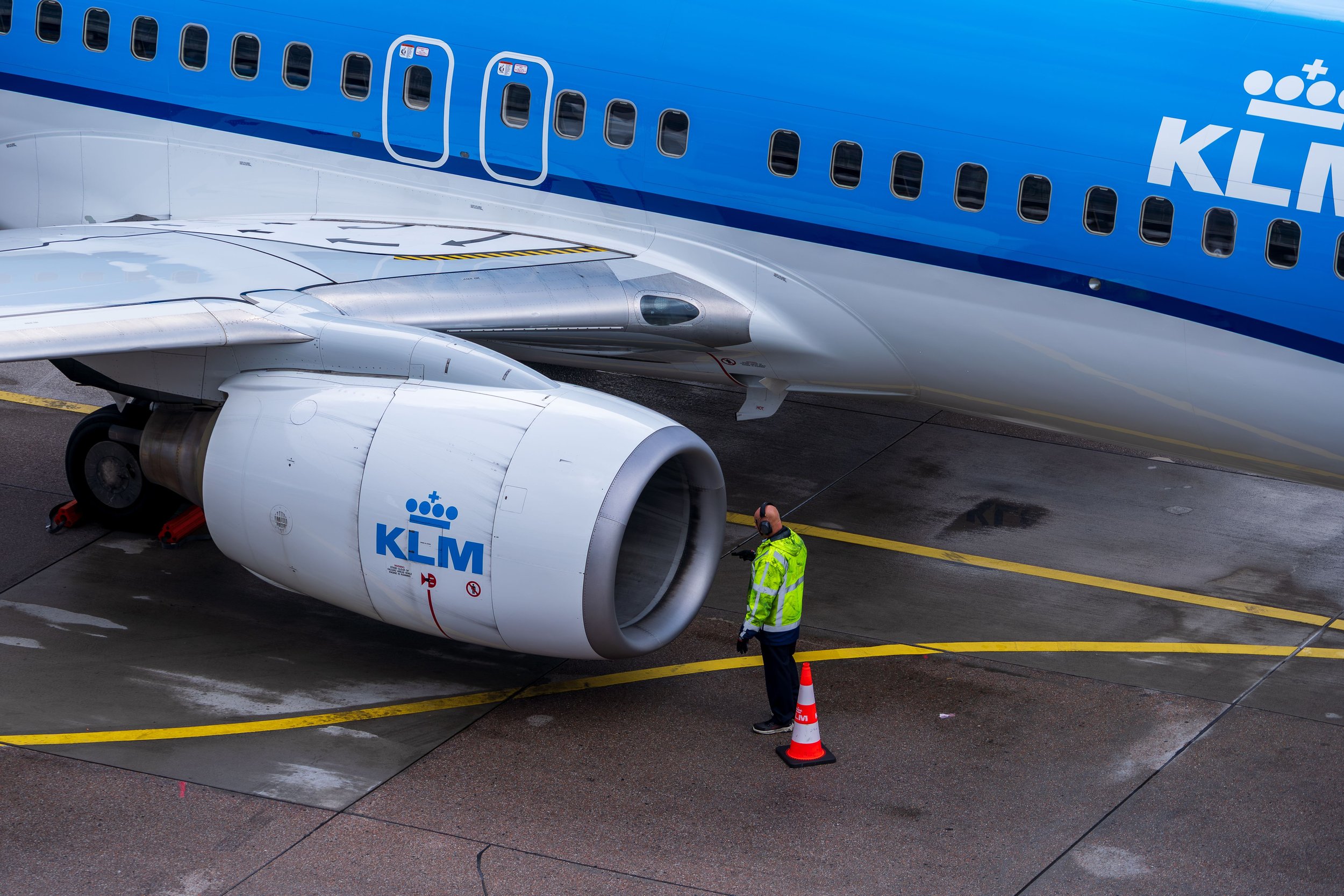 KLM aircraft on the ground with engine and wing visible during ground operations.