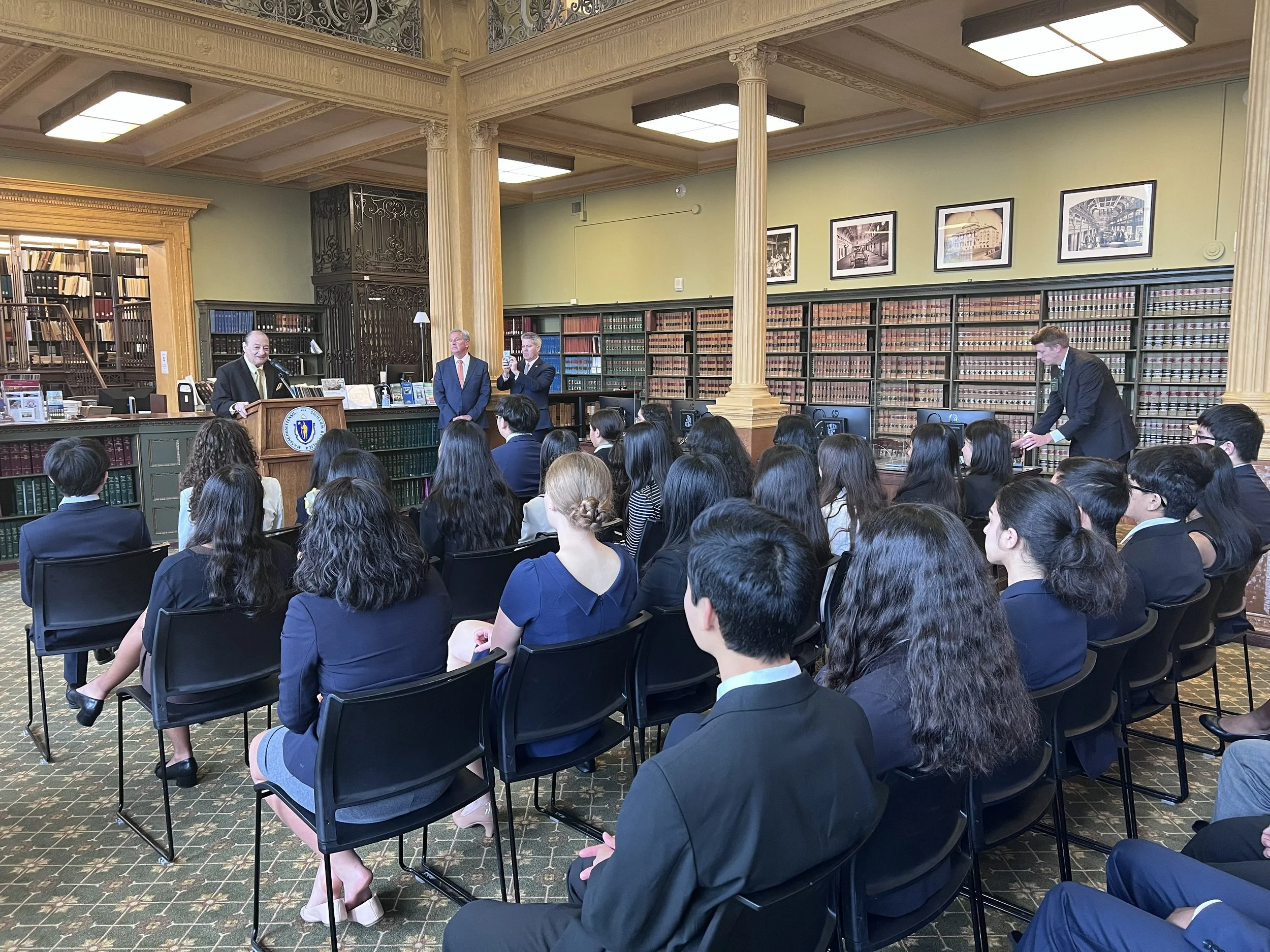  The Honorable Robert Cerasoli , a Coolidge Foundation trustee, addresses the Coolidge Senators at the Massachusetts State House. Standing near Cerasoli are State Representative  Bruce J. Ayers  and Norfolk County Superior Court Clerk  Walter Timilty