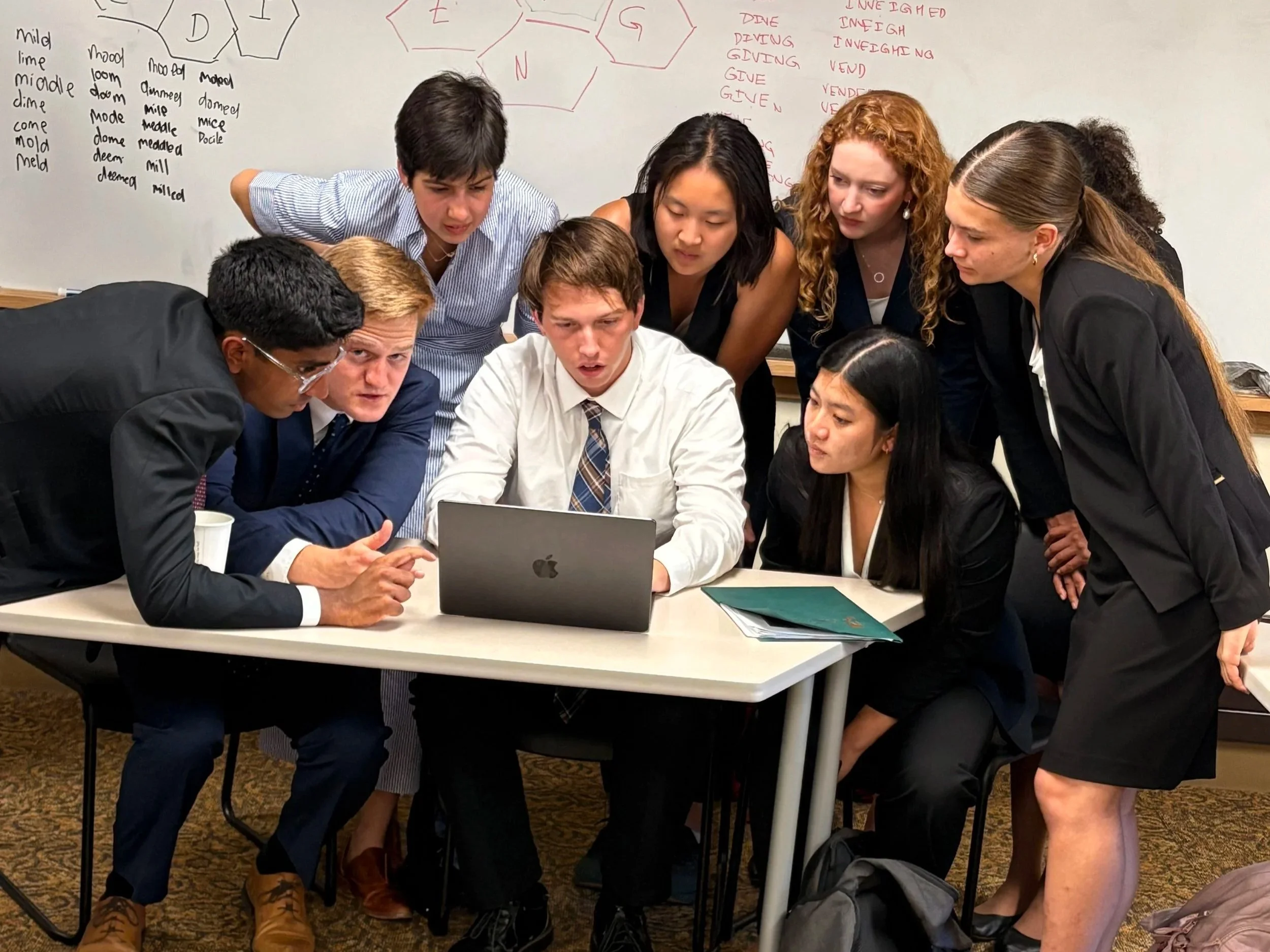 Scholars gather to work on a crossword puzzle together