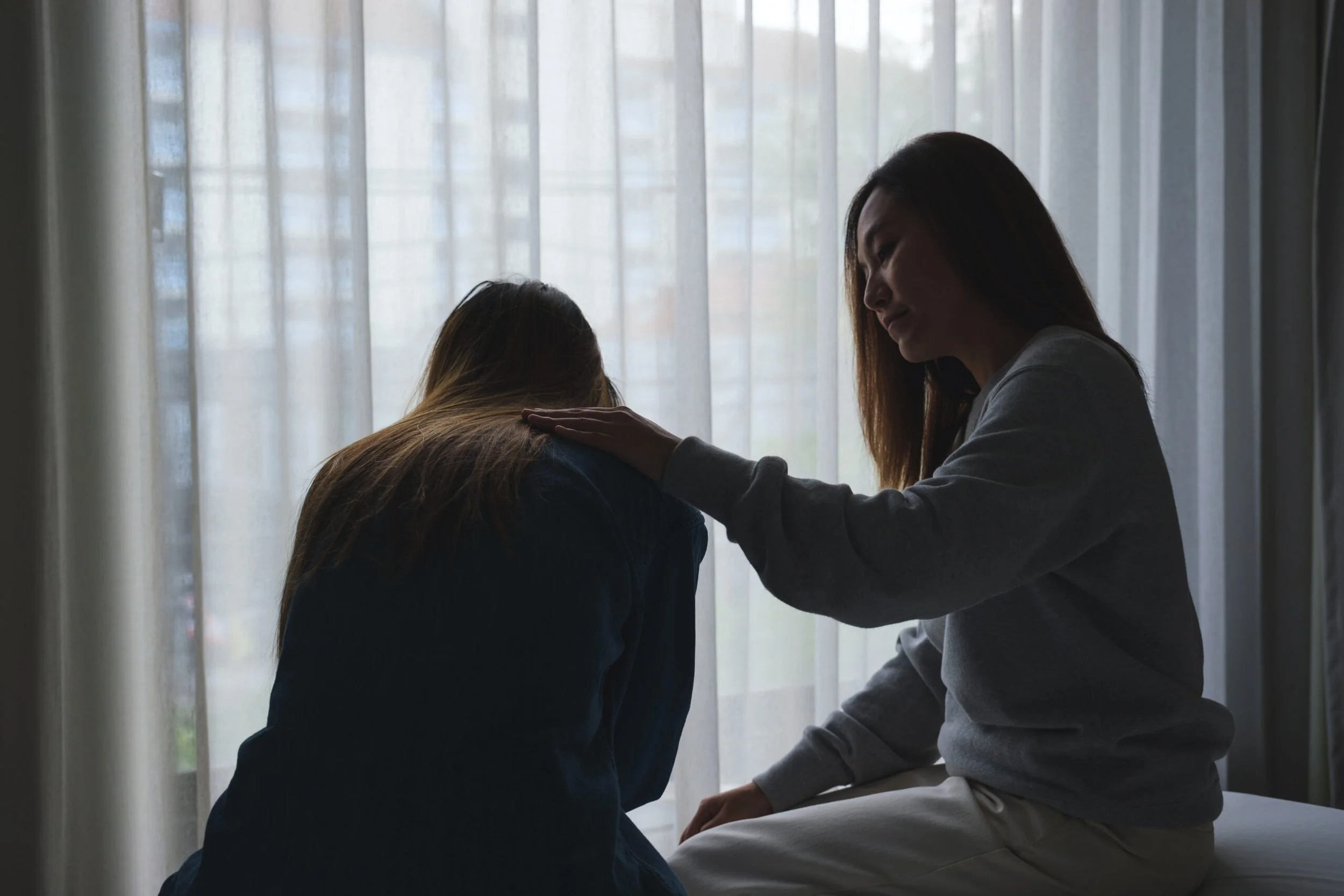 Mother comforting daughter