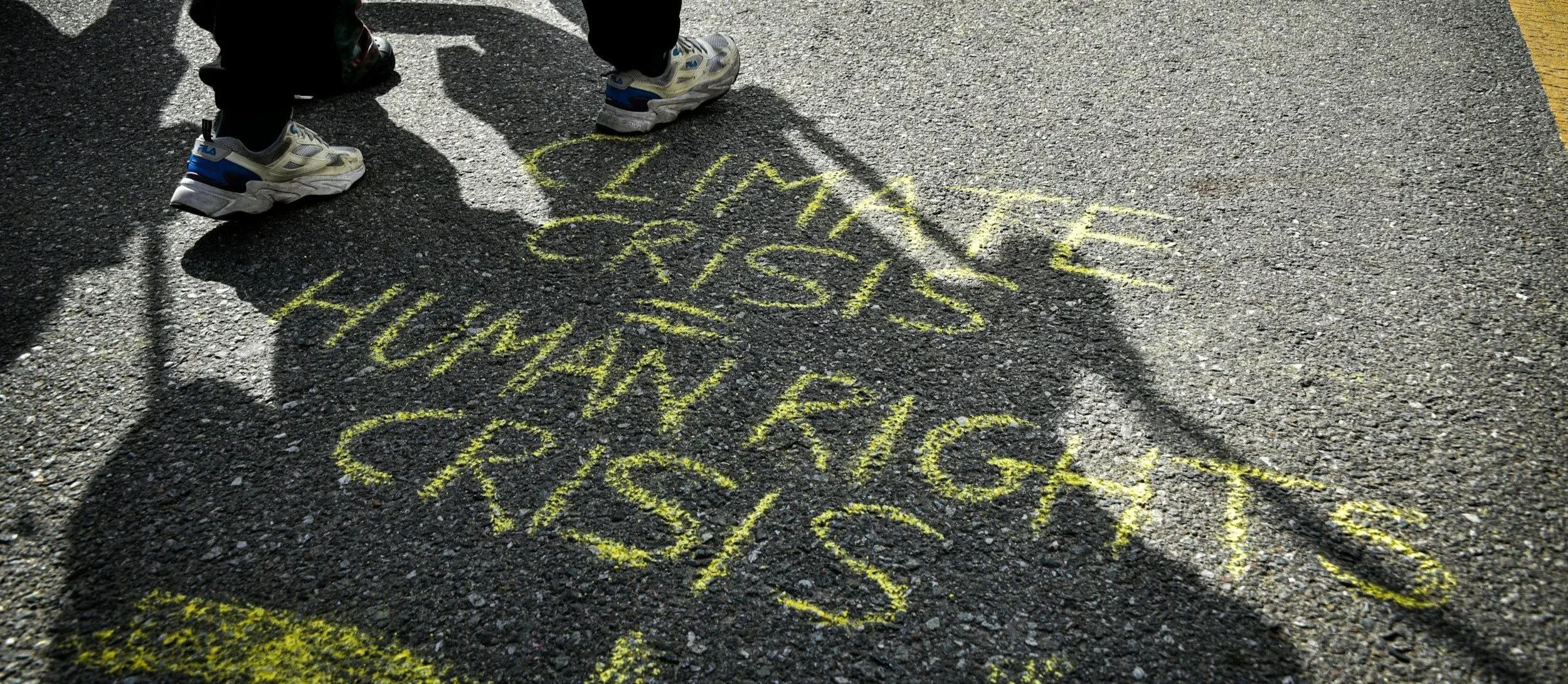 chalk writing "climate crise=humanrights crisis"
