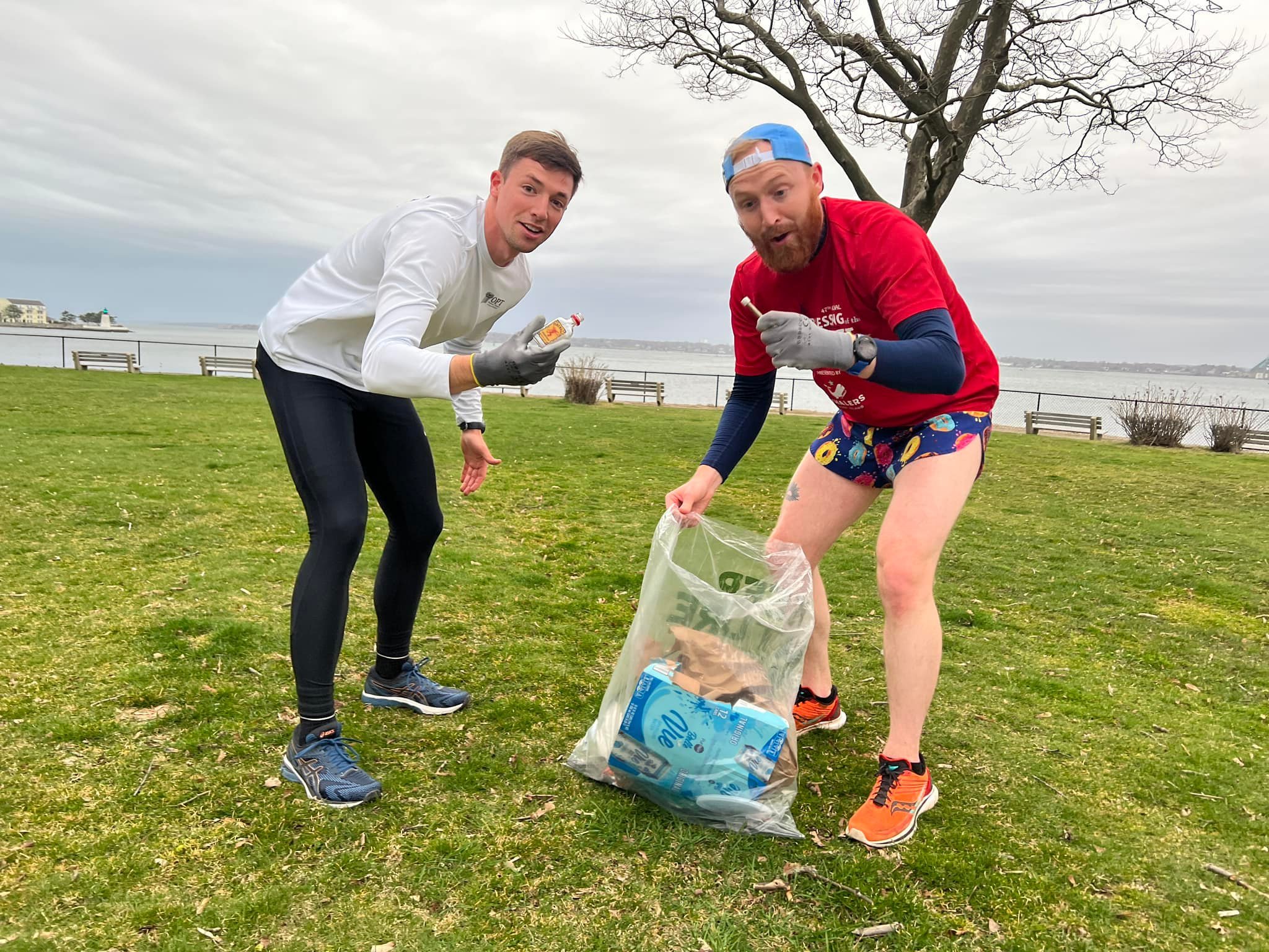 Leo Harmon and Jake Hassel pick up trash at Battery Park in Newport.jpeg