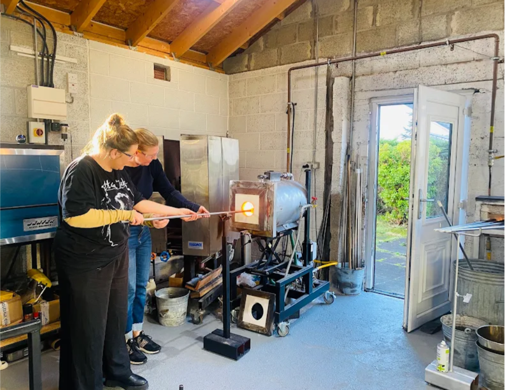 Elin Isaksson teaching glass blowing tobeginner