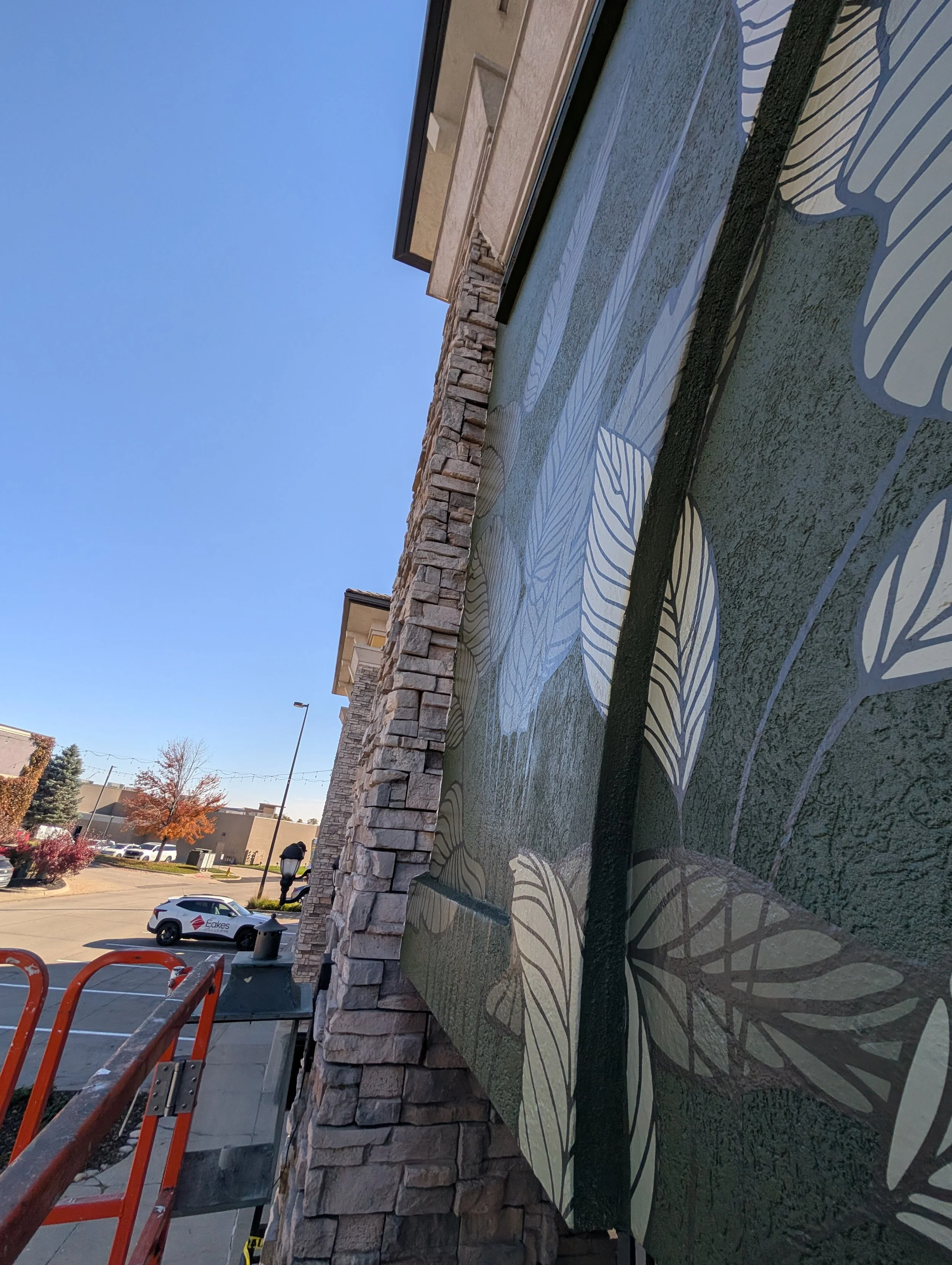 Wall mural graphics on rough outdoor exterior stucco surface