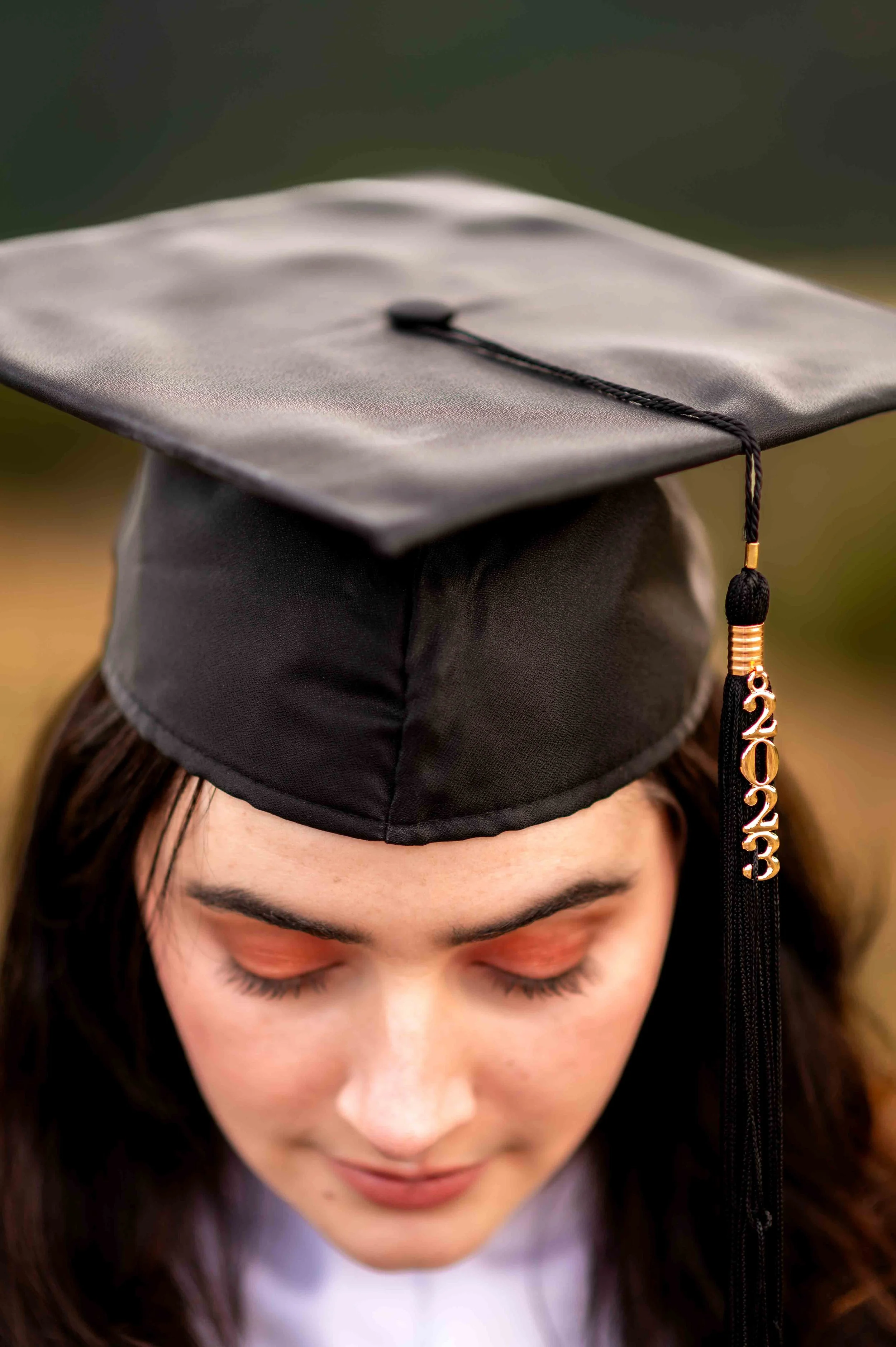 girl shows off her graduation cap during a session with the Longmont school photographer