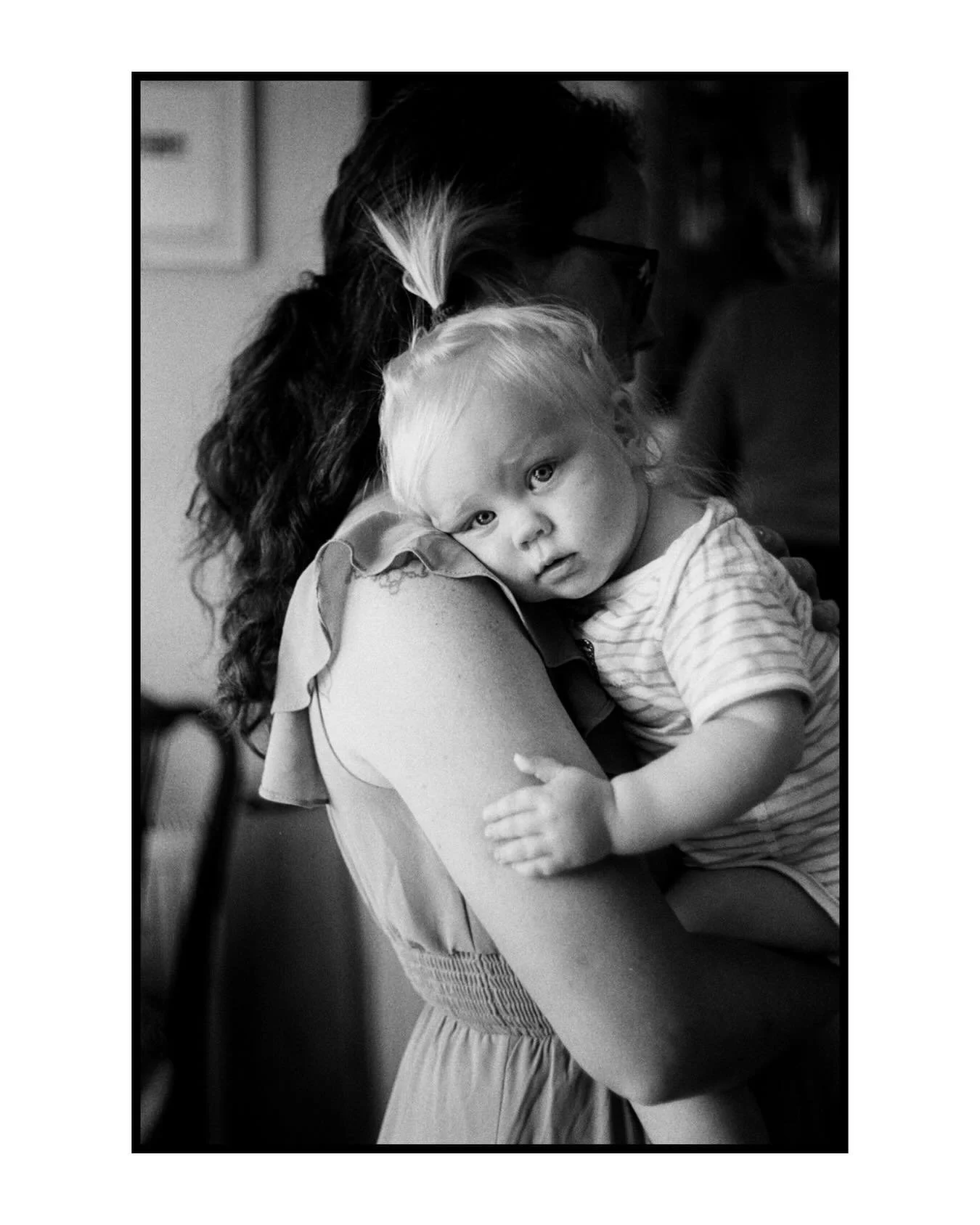 The instinctive curiosity of a child.

I was drawn to this moment instantly. 

Held safely in her mother&rsquo;s arms yet looking straight towards the camera with that quiet but calm curiosity only a child has. 

These are the moments that catch my e