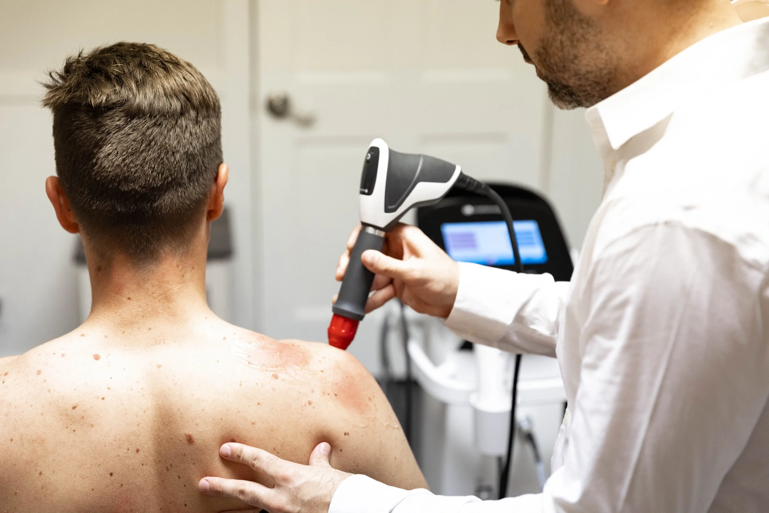 Dr. Sean Hammonds providing shockwave treatments at Foundations Health and Wellness in Fuquay Varina, NC