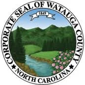 Seal of Watauga County, North Carolina with mountains, trees, and flowers.