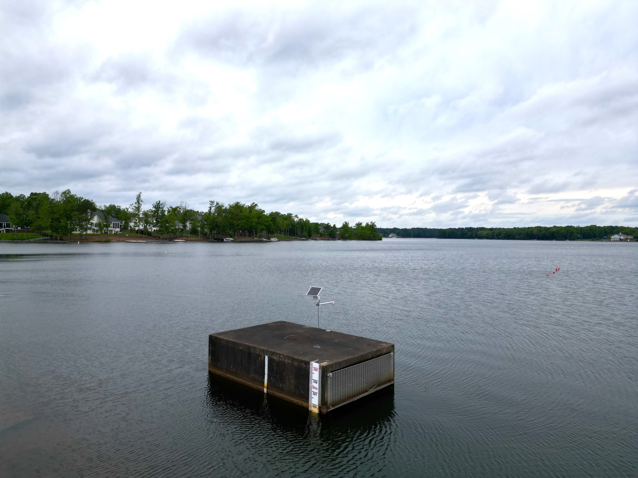 Drone view of a water level sensor monitoring levels in a reservoir subject to both droughts and floods.