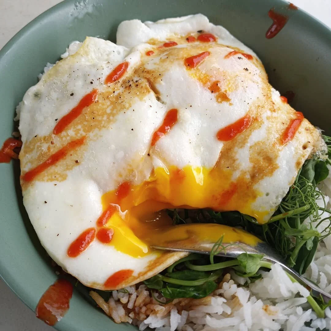 Farm fresh eggs, peashoots, and rice. Topped with a bit of Sriracha on top. 🤤🤤🤤