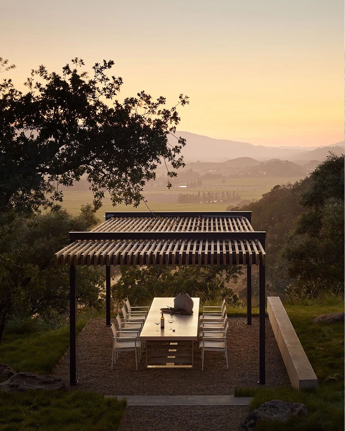 This may be the most magnificent private dining settings in the Napa Valley. What do you think?
The outdoor dining pavilion featuring a 14-foot custom cast concrete dining table, mirrors the rhythm of the vineyard rows below, creating a space where a