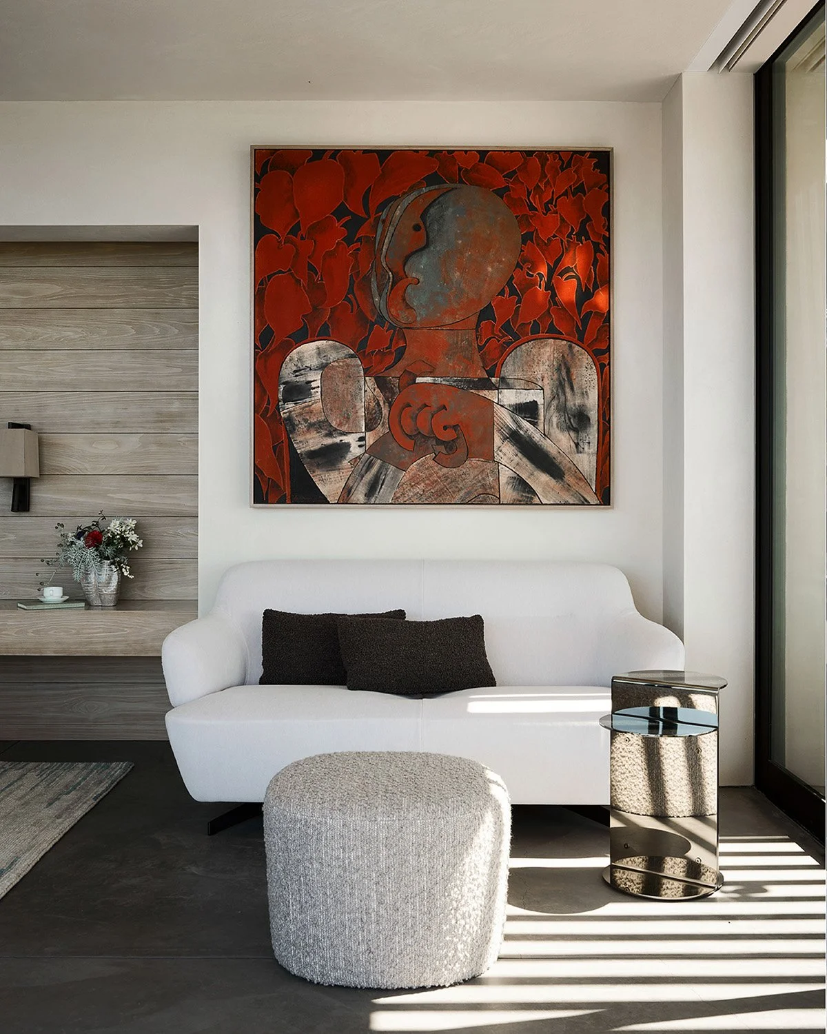 Art becomes the anchor. A bold, expressive painting sets the tone, balanced by soft forms, textured fabrics, and sunlight that moves gently across the room.

It&rsquo;s a small space with a big presence&mdash;proof that thoughtful composition can tra