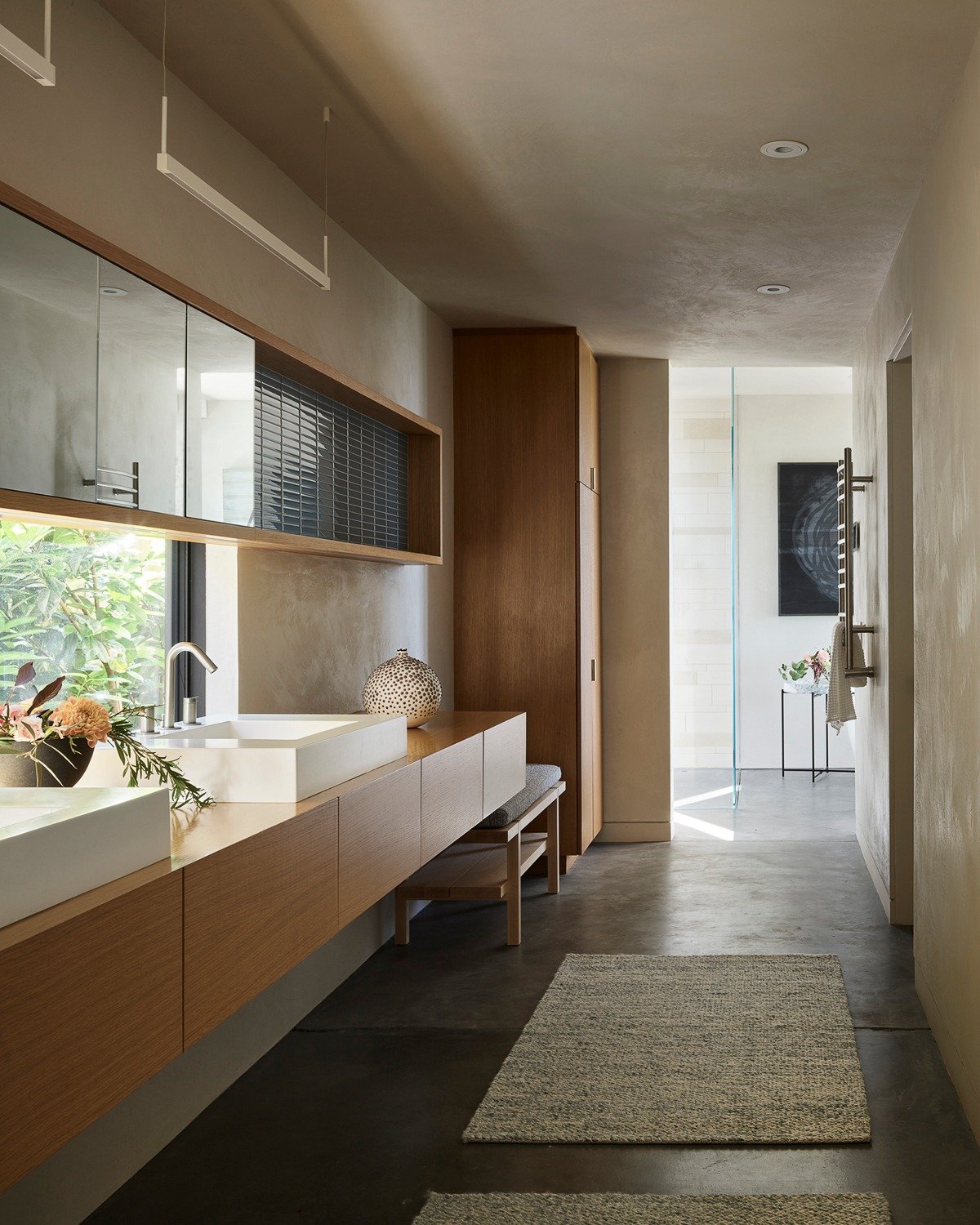 Quiet luxury begins with simplicity.
Soft light, warm woods, and sculptural fixtures bring a calm, spa-like serenity to the primary bath&mdash;an intimate retreat designed for restoration and pause.

Architect @aidlindarlingdesign 
Builder @eamescons