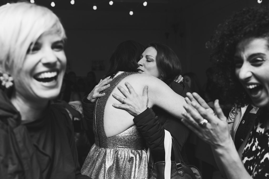 women embrace at a party black and white image