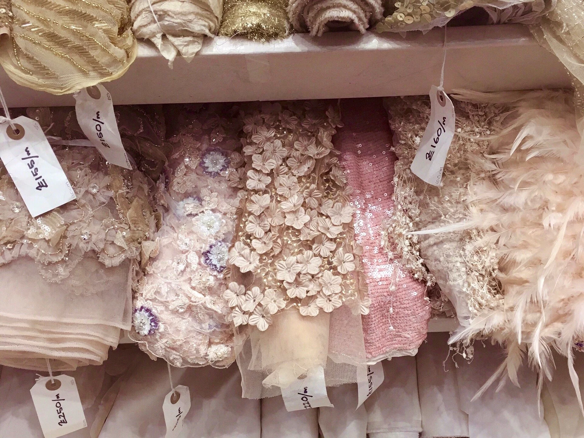 Rolls beautiful beaded tulle and lace in a fabric merchant in Soho, London