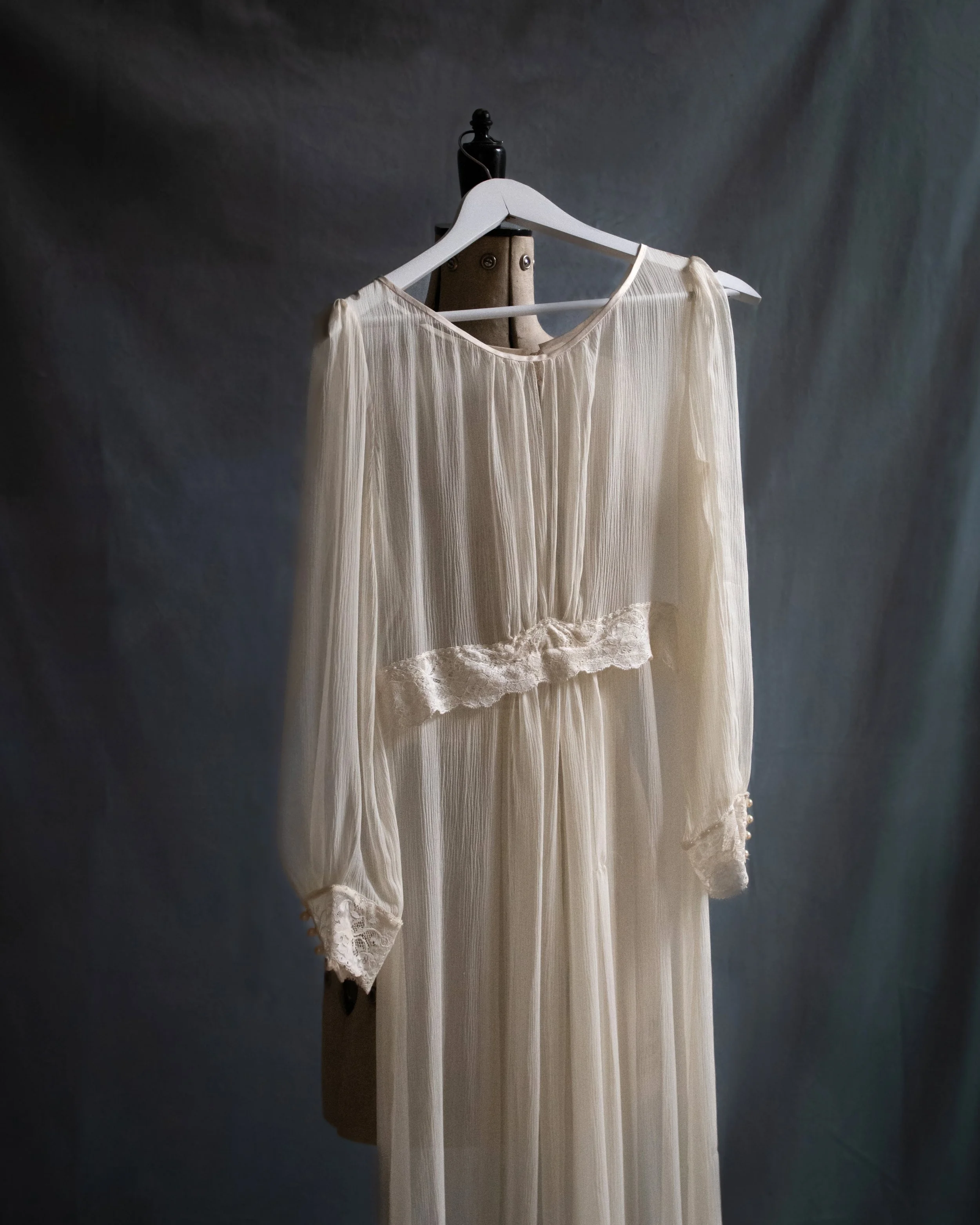 A silk chiffon dress hung on an mannequin