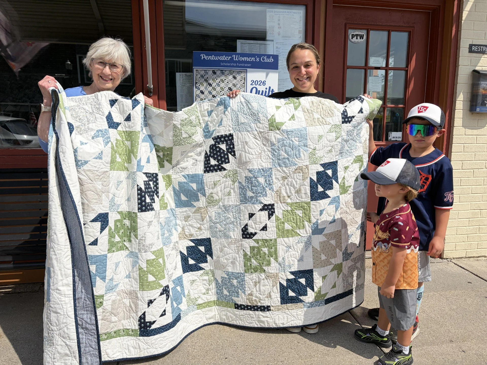 The 2026 quilt being presented to the raffle winner.