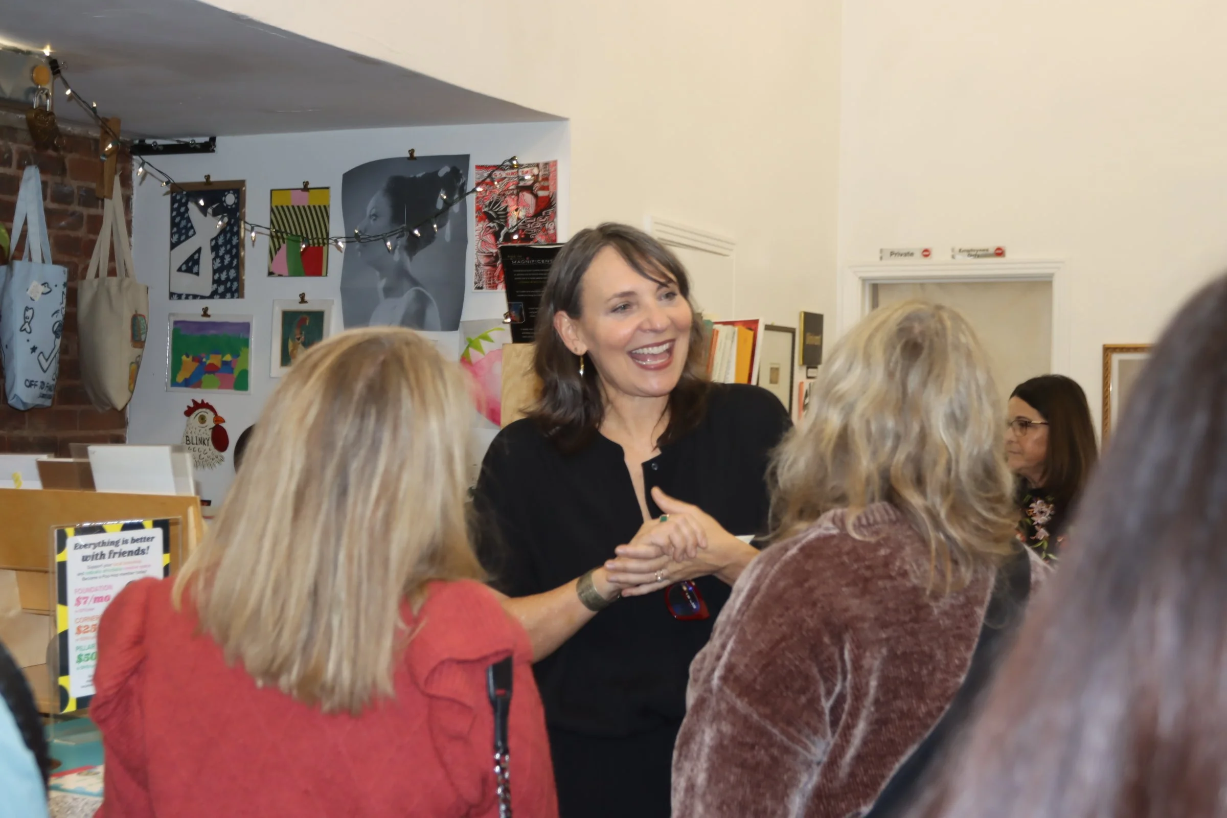 Arianne talking with people at Book Launch Event