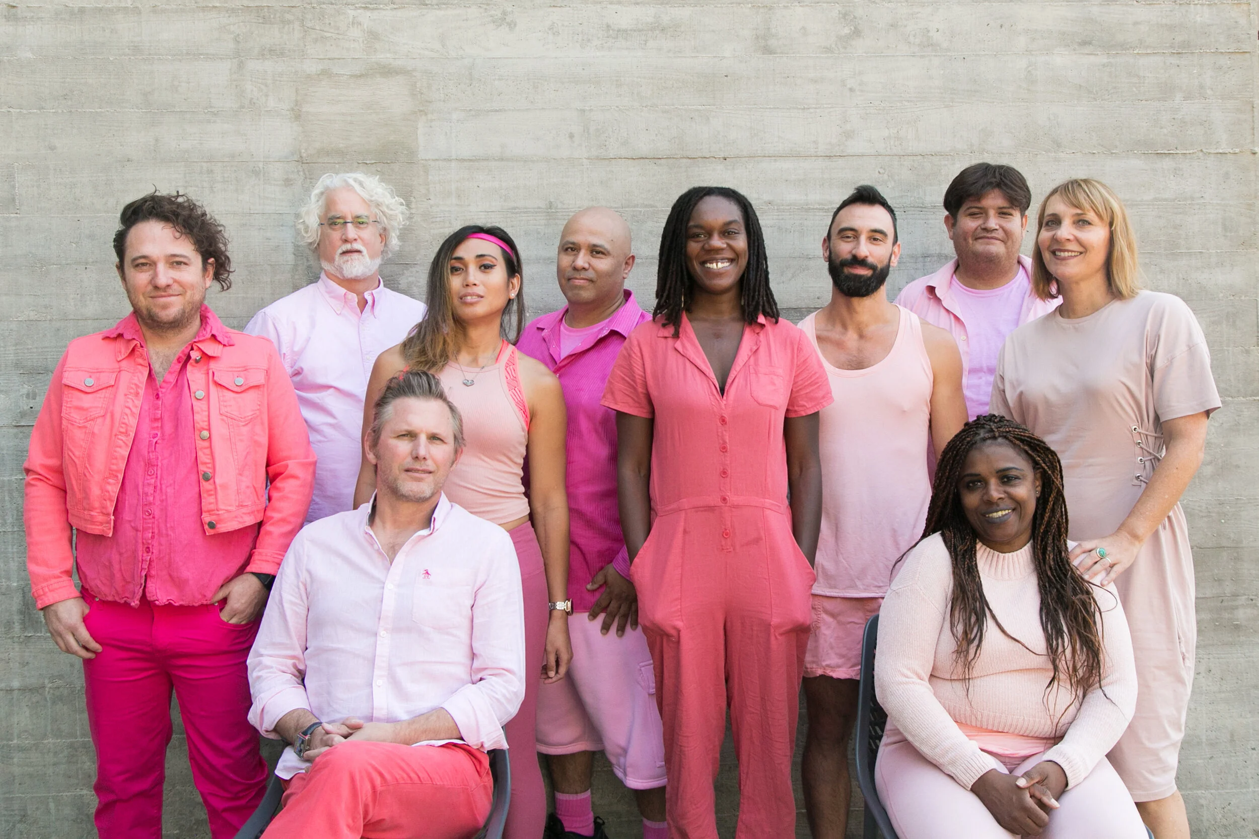 Collective Memory Project Members Portrait dressed in shades of pinkagainst concrete wall