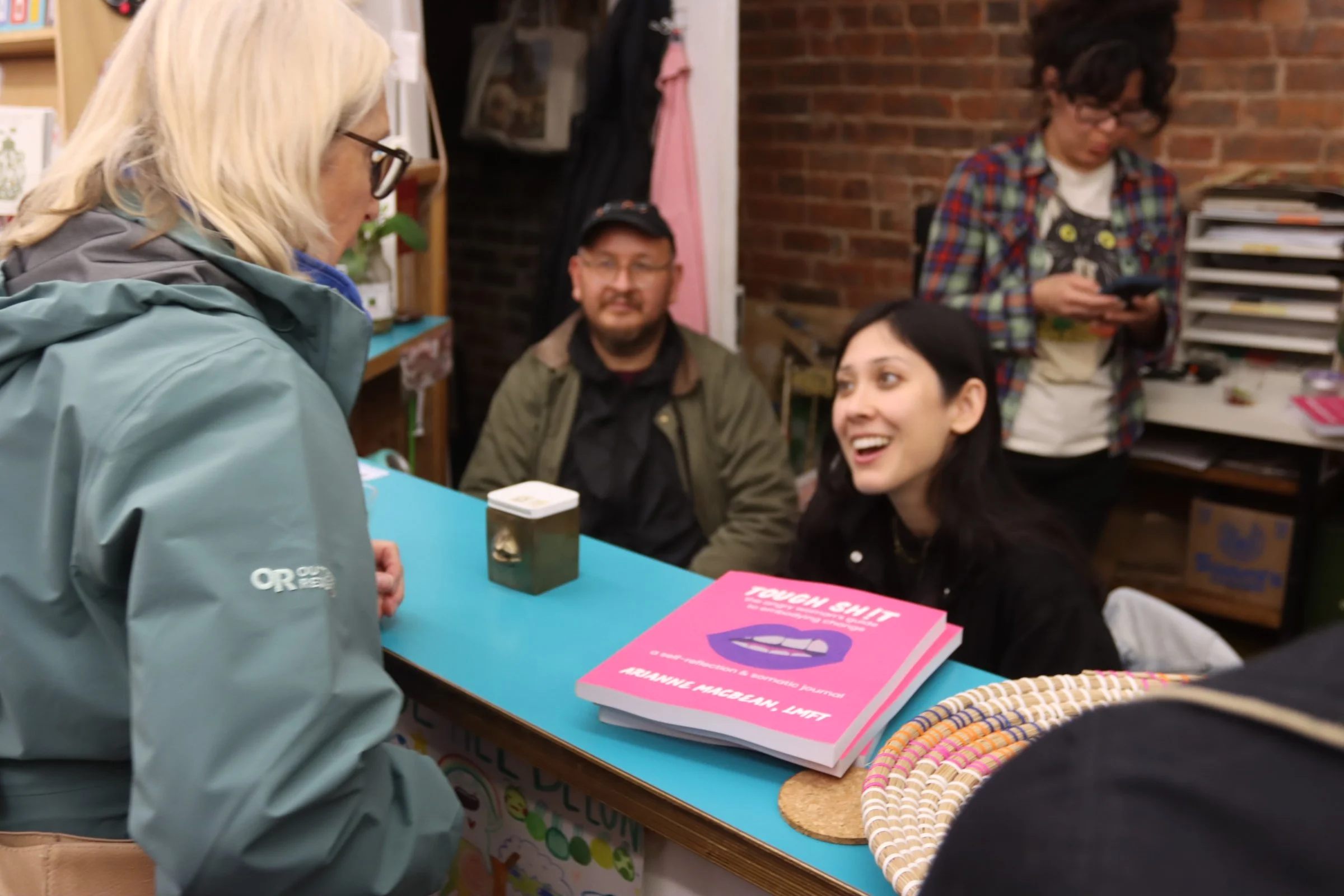 Person Buying Tough Shit Book front book store sales counter