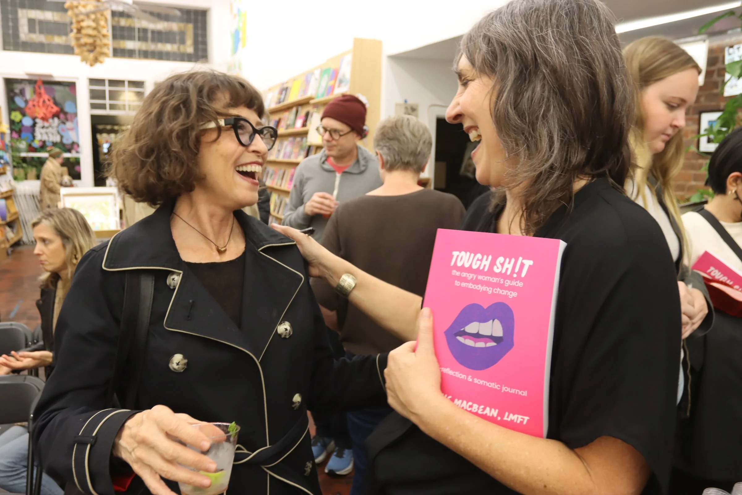 Arianne with Book laughing with attendee of Book launch event