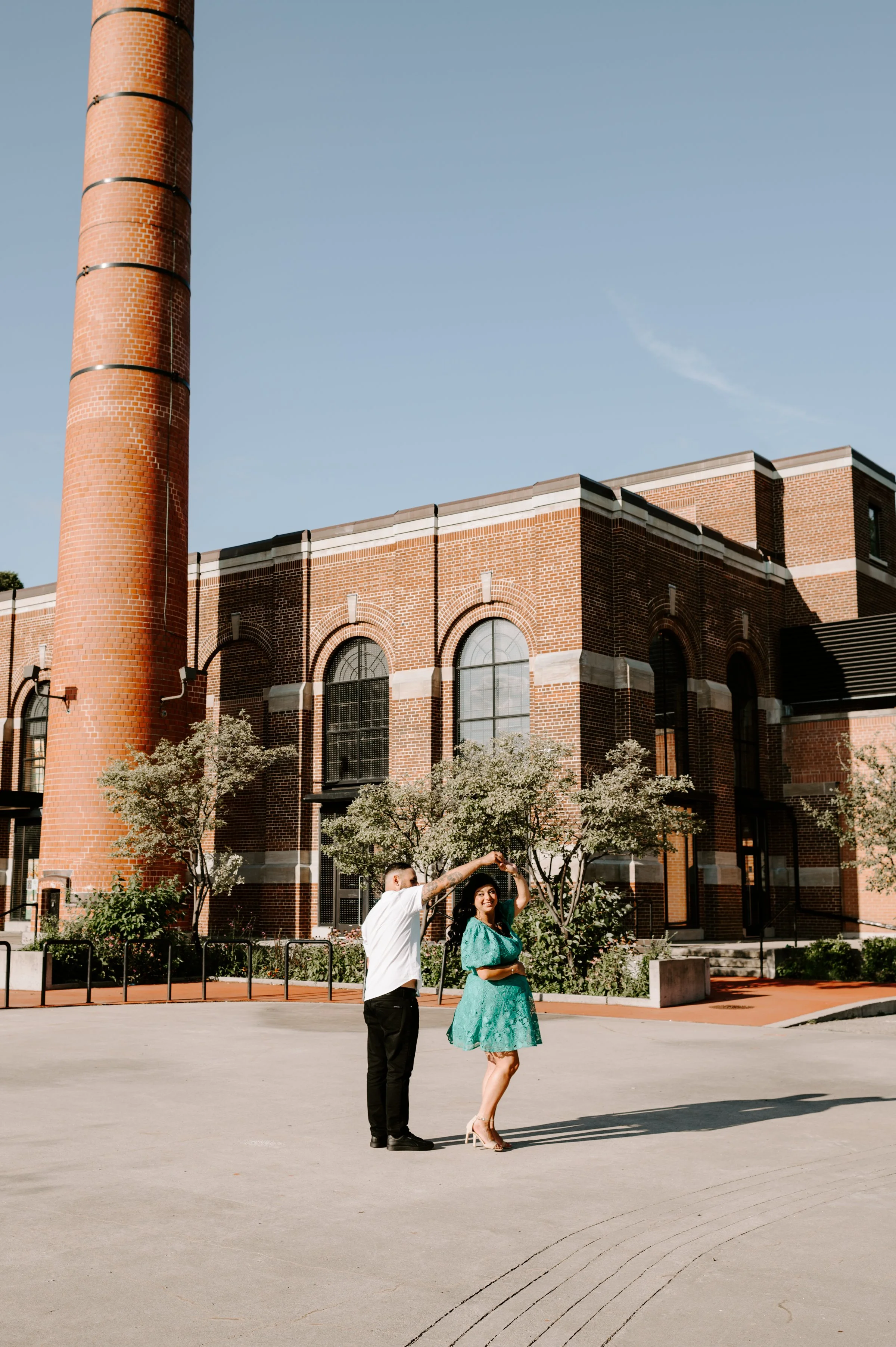 outdoor maternity session at Colonel Samuel Smith Park. Mother to be is weather short green lace dress and dad to be is wearing black jeans and white button up top