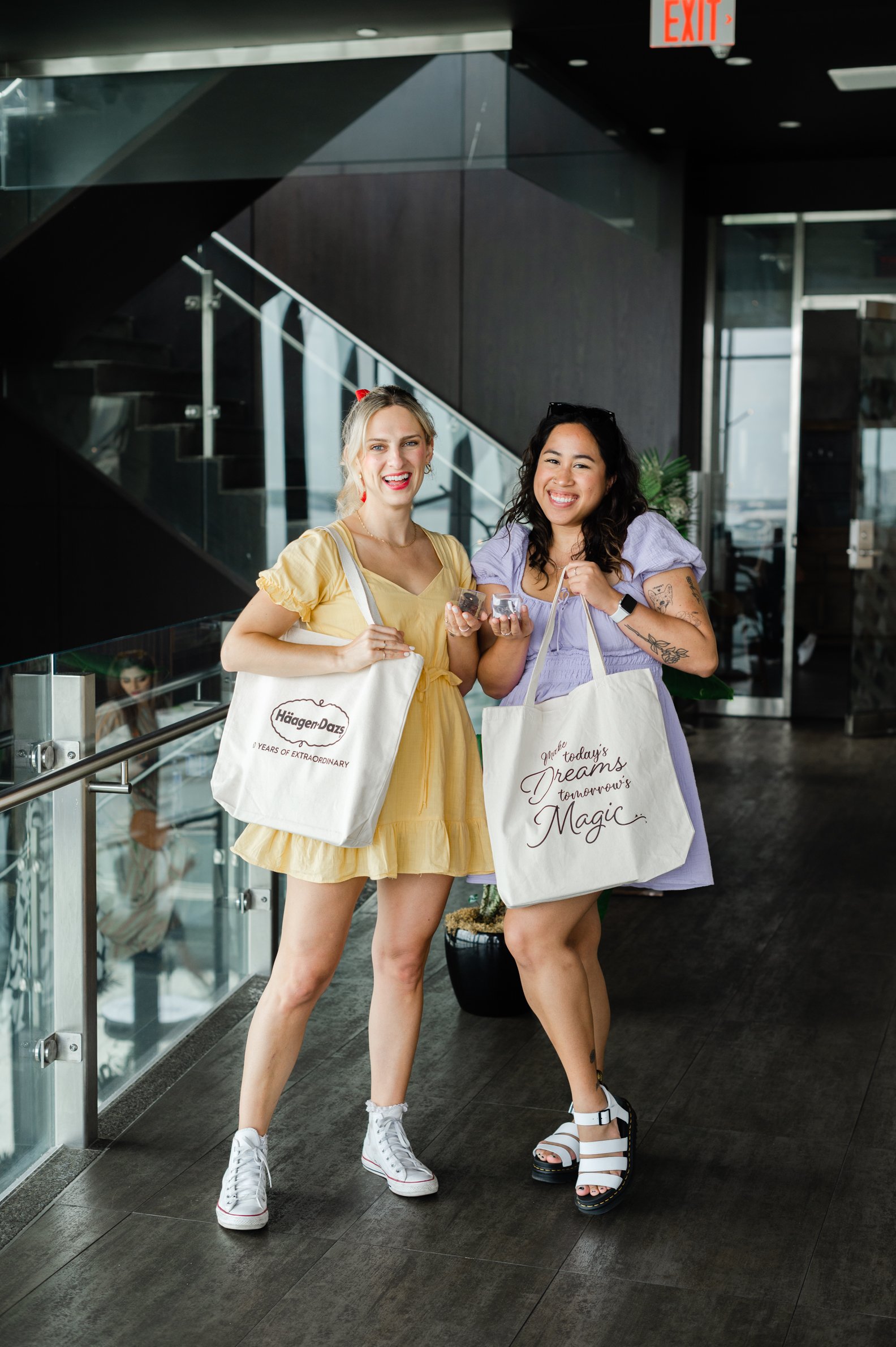 Two influencers posing with their event gift bags. Influencer event photographer, influencer event photography, GTA influencer event photographer