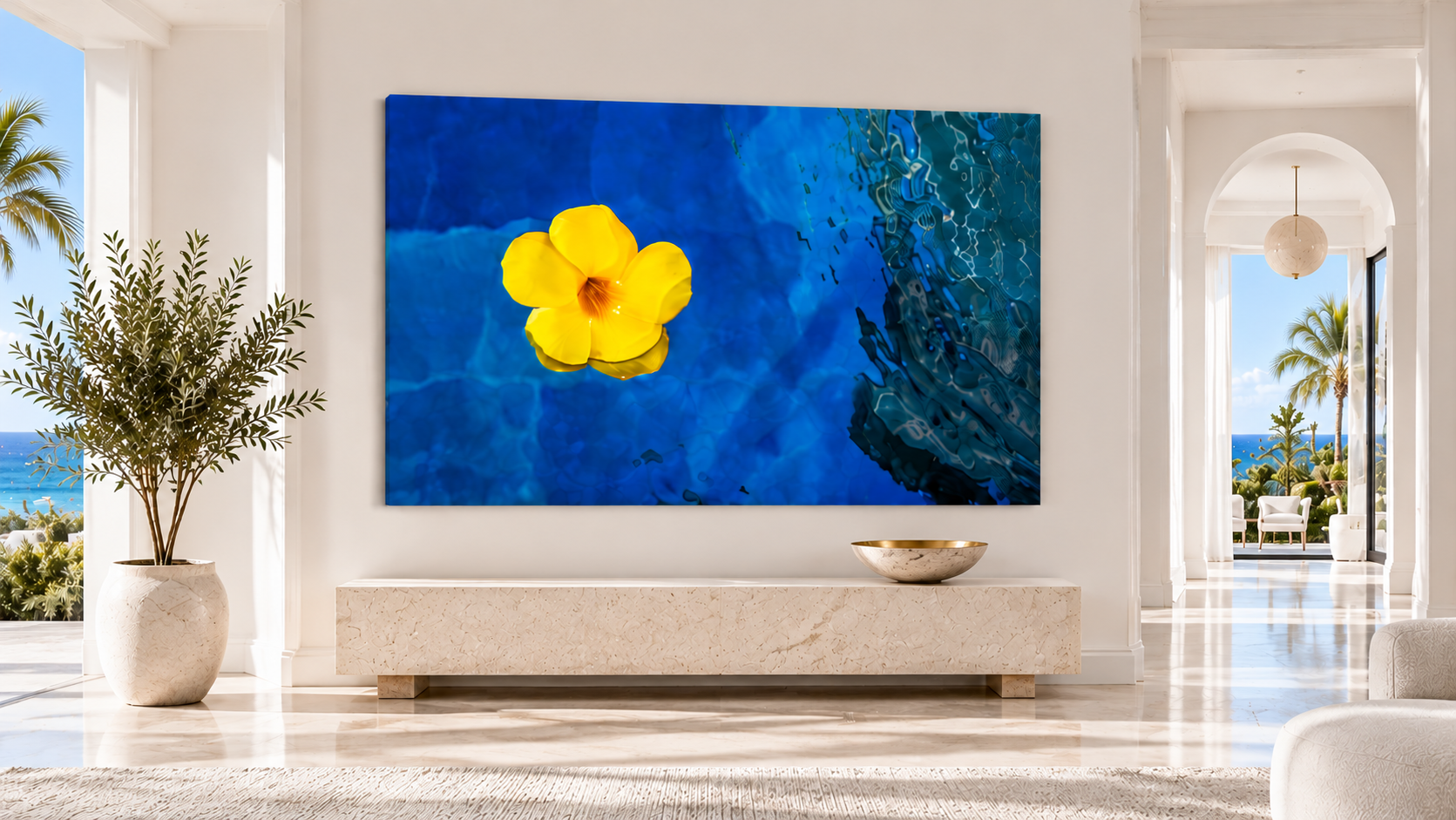 Blue Hour fine-art photograph of a yellow flower floating in deep blue water, displayed as glossy acrylic wall art in a luxurious Palm Beach-inspired entryway.