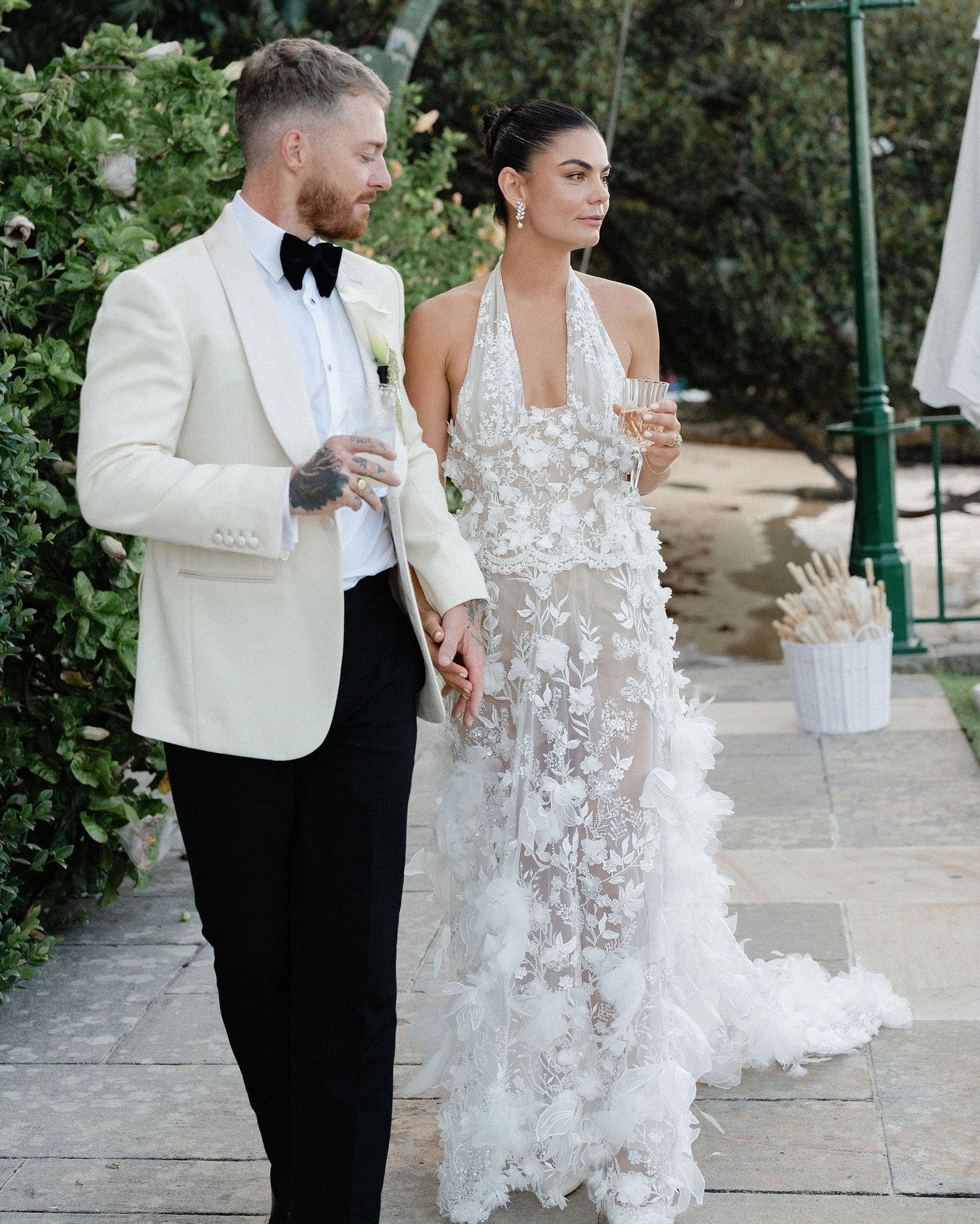Charles &amp; Eli 
The groom looking sharp in an ivory barathea dinner jacket with wide shawl lapels finished in silk grosgrain, paired with black barathea trousers.
A refined wedding look for their stunning day, elegant, confident, and timeless.

Cl