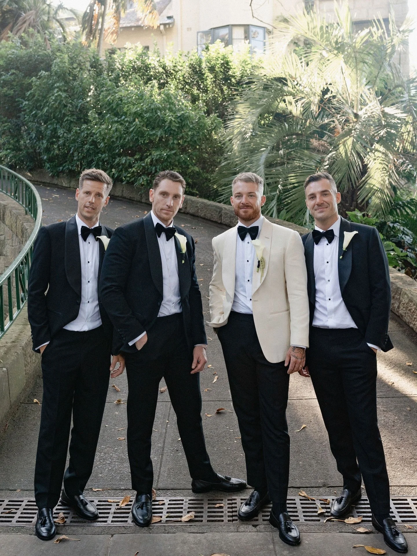 Charles with his groomsmen.
The groom set apart in ivory dinner jacket, alongside groomsmen in classic black tuxedos, finished with satin shawl lapels.

Groom cloth @hollandandsherryapparel 
Groomsmen cloth @dugdalebrosandco 

Photography by @nathan.