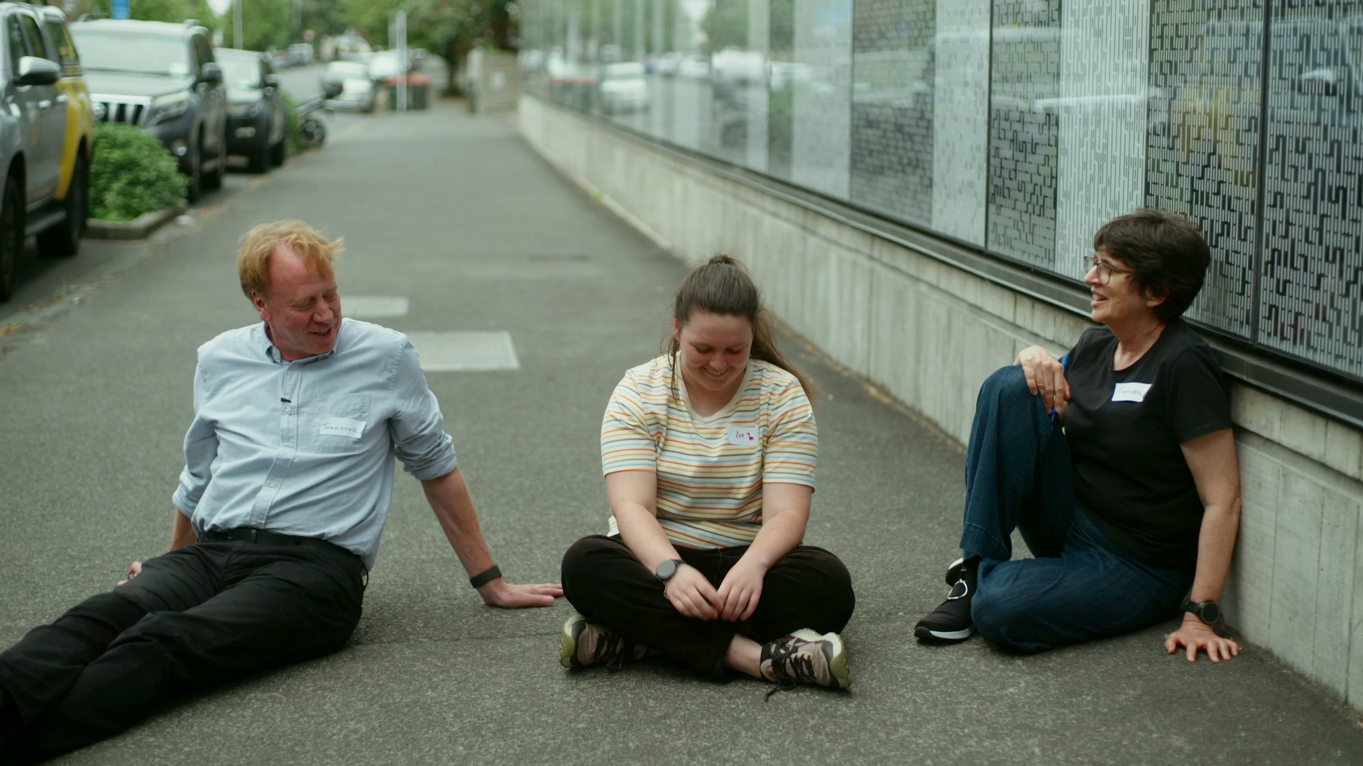 Zoe and psychologists sit on pavement.png