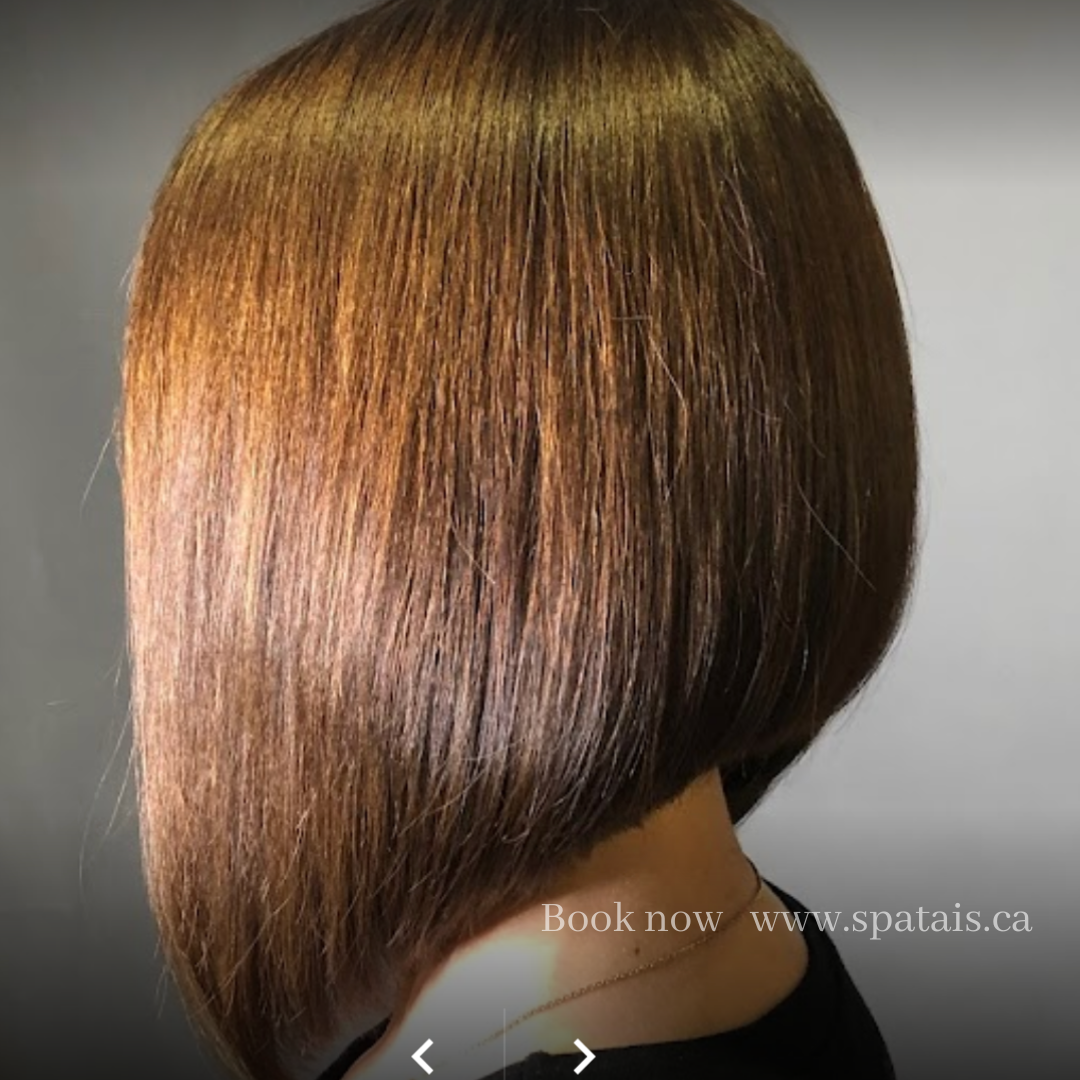Side view of a woman with a straight, sleek, layered bob hairstyle with reddish-brown hair color.