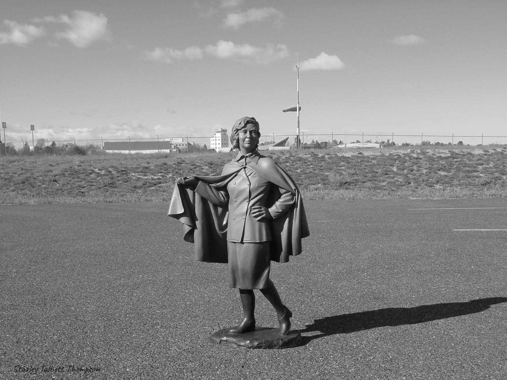 Bronze sculpture of Ellen Church at the Cheyenne Regional Airport, with the former airport in the background. Photo by Starley Talbott Thompson.