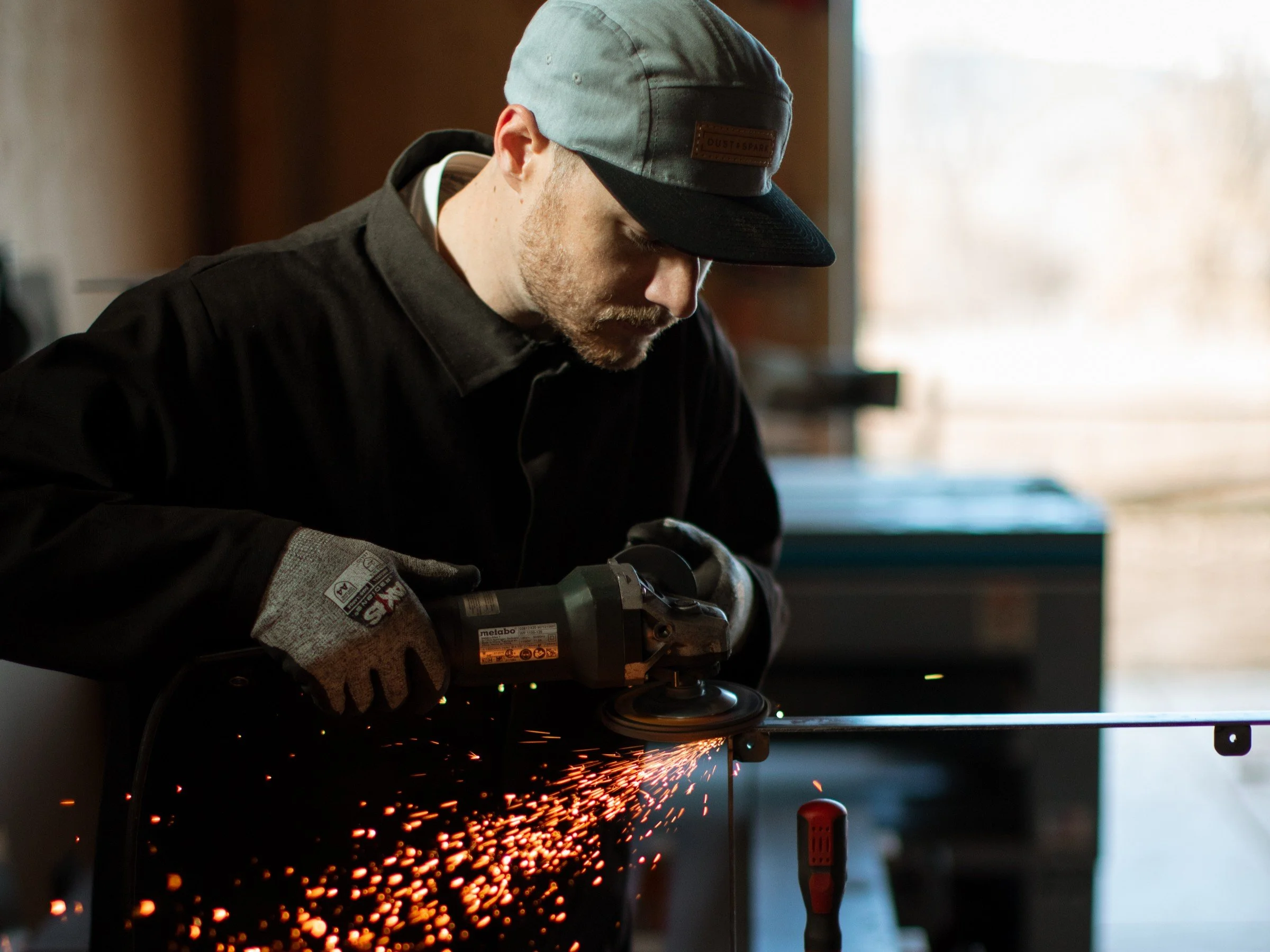 Scott Hensen using the angle grinder to blend a welded part
